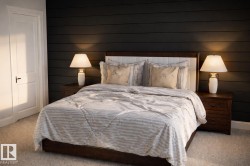 This bedroom features a dark shiplap accent wall and light-colored carpeting -