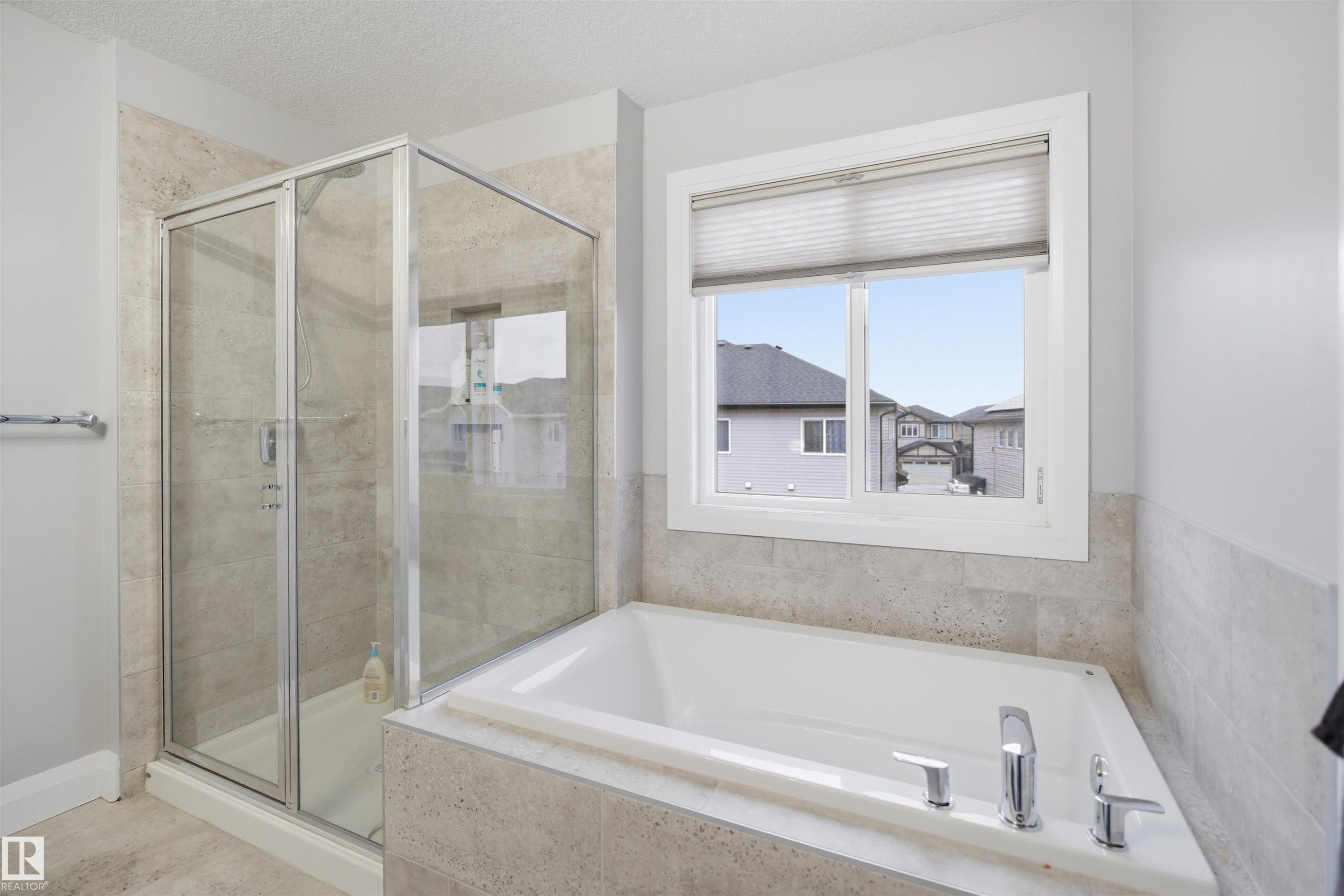 Bathroom featuring a built-in bathtub, a walk-in shower with a glass enclosure, and a window with blinds - 8424 Cushing Court, Edmonton, AB - Indoor Photo Showing Bathroom