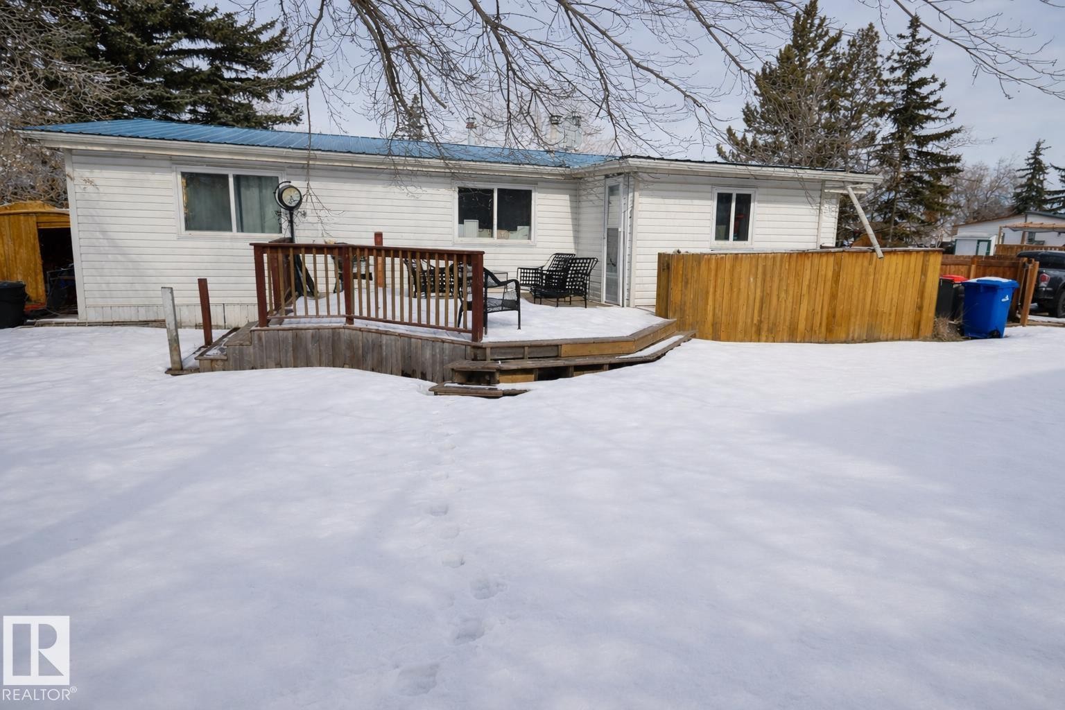 The property features a private deck with wooden railings and steps, and a wooden privacy screen - 11 Willow Park Estates, Leduc, AB - Outdoor With Deck Patio Veranda