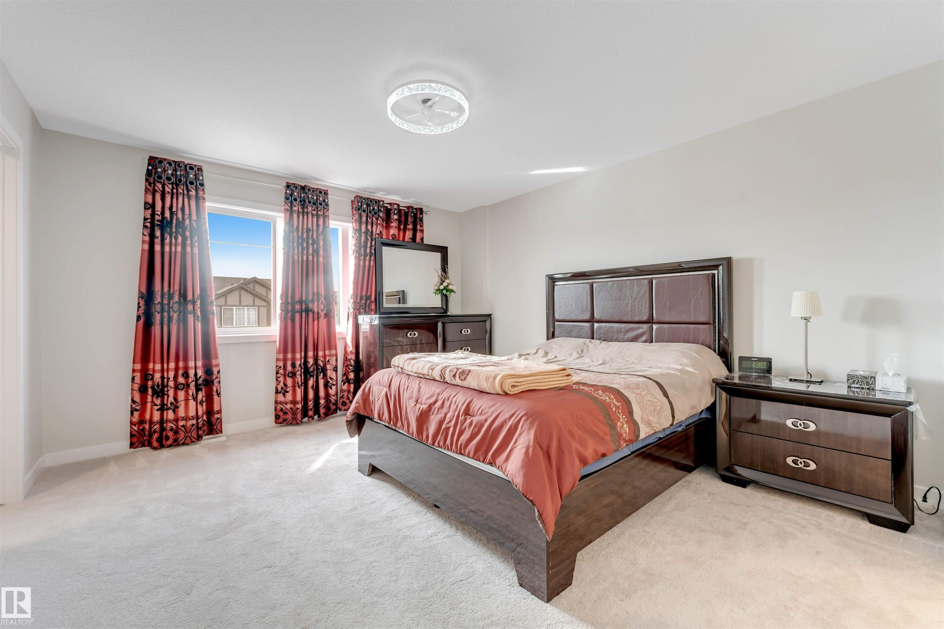 The room features plush carpeting and three windows providing natural light - 6404 27 Avenue, Edmonton, AB - Indoor Photo Showing Bedroom