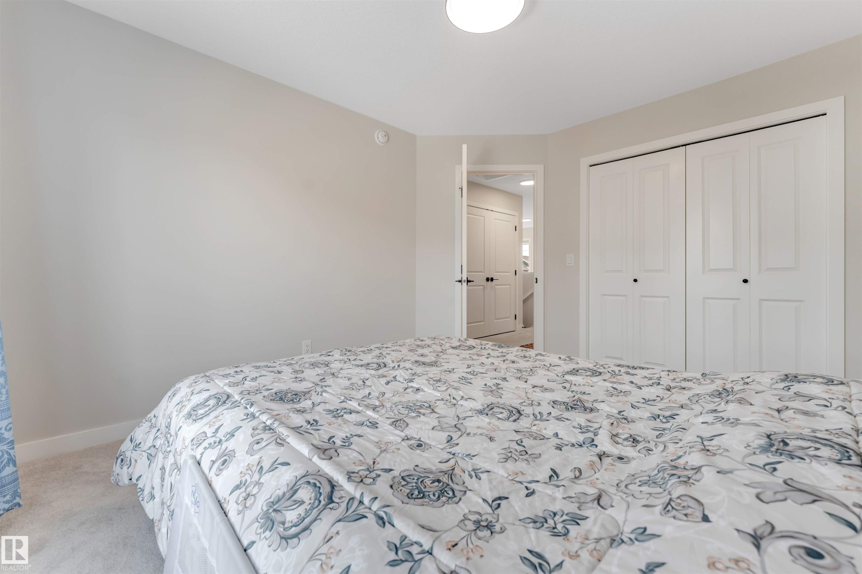 This room features light-colored walls and carpeted flooring - 6404 27 Avenue, Edmonton, AB - Indoor Photo Showing Bedroom
