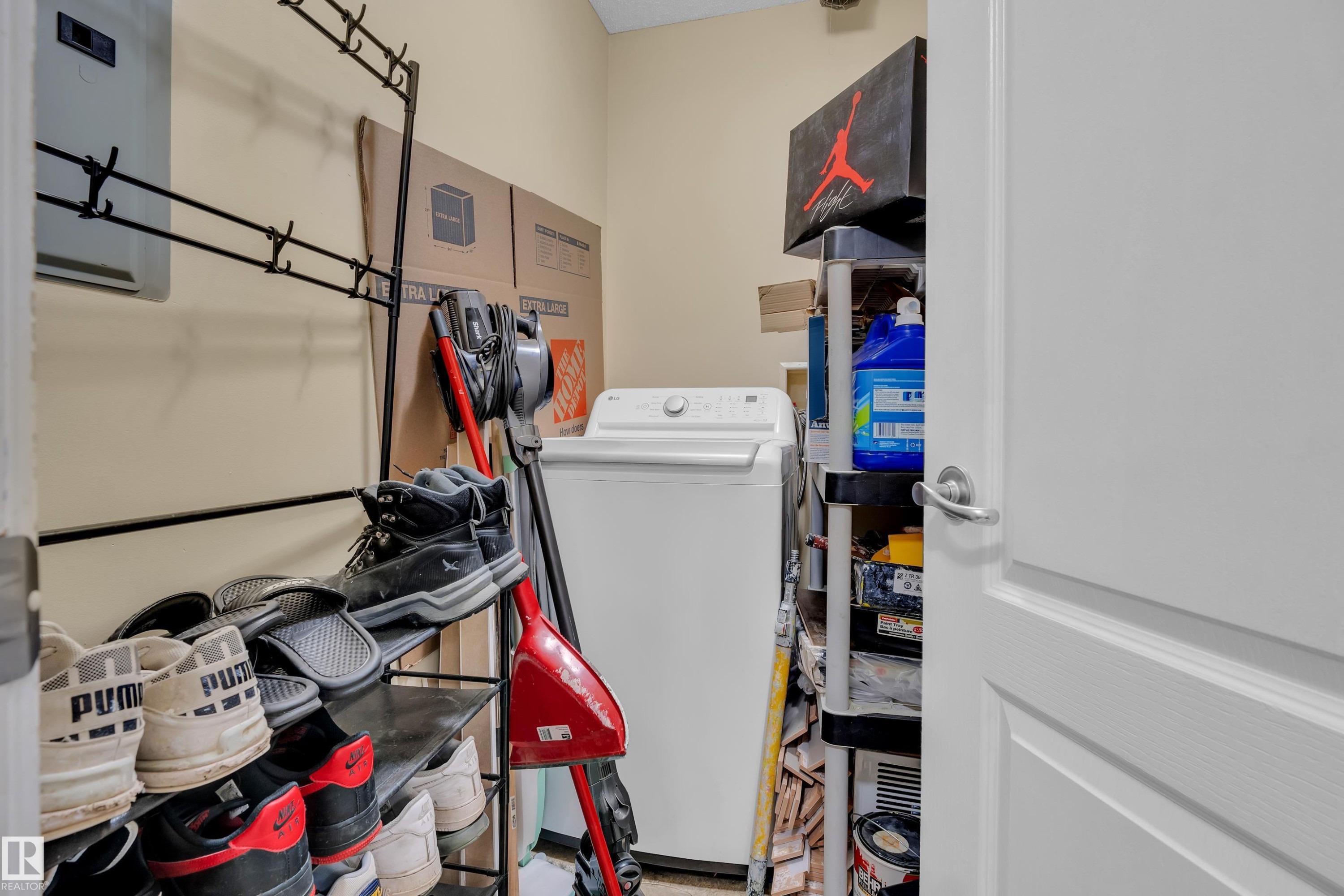 Utility area featuring a white top-loading washing machine and a wall-mounted coat rack - 320 392 Silver Berry Road, Edmonton, AB - Indoor Photo Showing Laundry Room