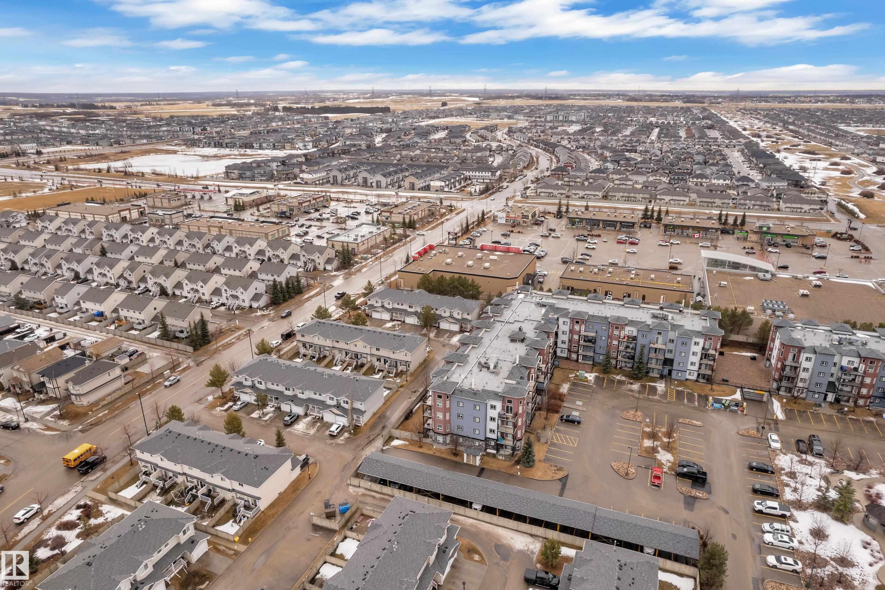 Aerial view of the community, showcasing residential buildings and commercial properties - 320 392 Silver Berry Road, Edmonton, AB - Outdoor With View