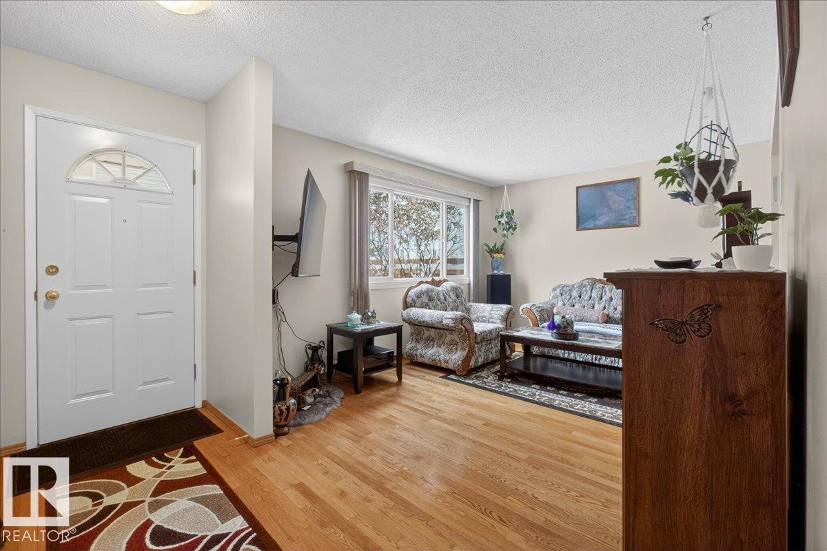 The living area features hardwood floors and a window providing natural light - 2 Mcleod Place, Edmonton, AB - Indoor