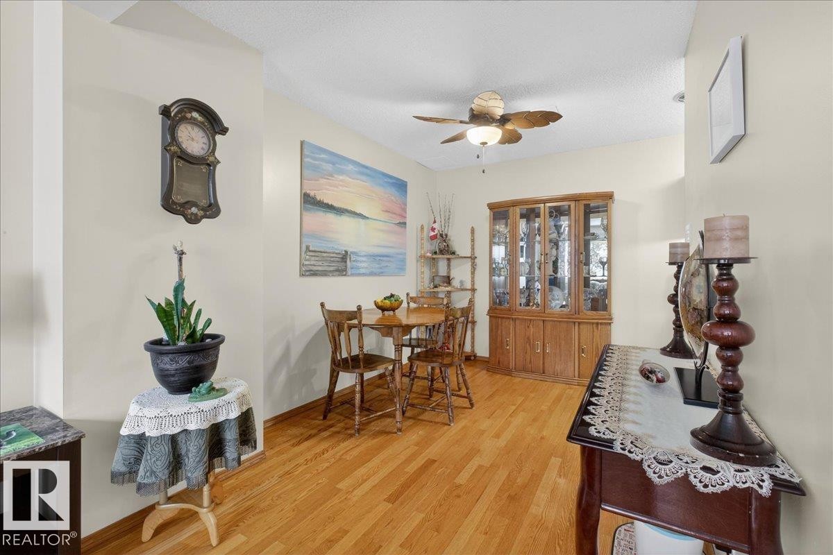 This dining area features light-colored walls and hardwood flooring - 2 Mcleod Place, Edmonton, AB - Indoor Photo Showing Other Room