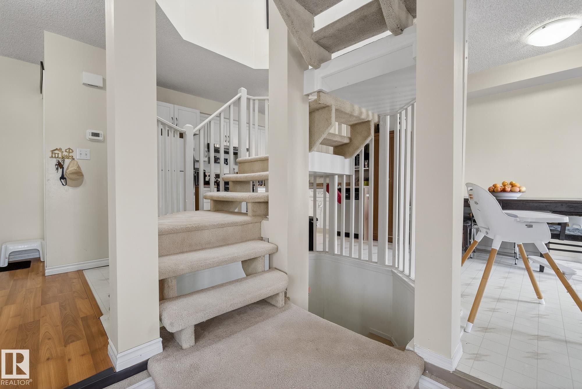 Carpeted staircase with white balusters and handrails - 2006 Mill Woods Road E, Edmonton, AB - Indoor Photo Showing Other Room