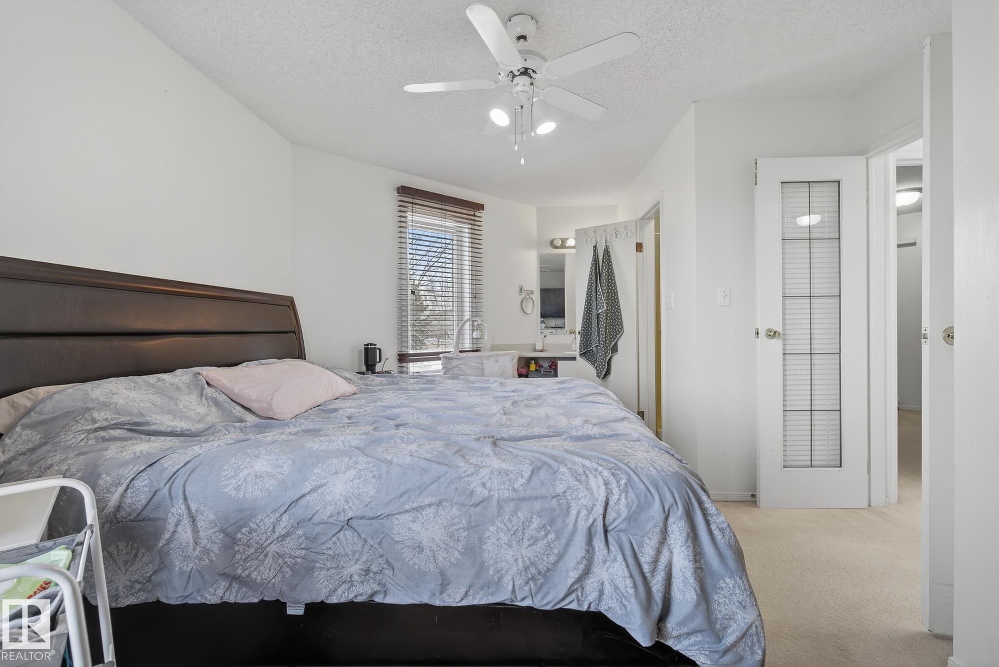 Bedroom featuring a ceiling fan, a window with blinds, and light-colored carpeting - 2006 Mill Woods Road E, Edmonton, AB - Indoor Photo Showing Bedroom
