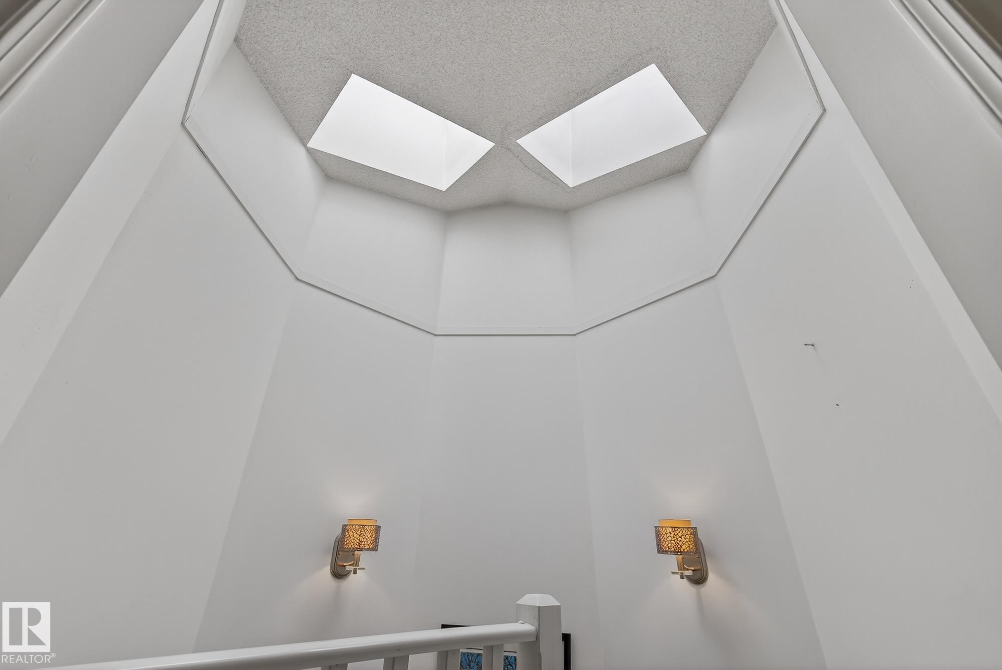 This bright entryway features a high ceiling with two skylights, illuminating the space - 2006 Mill Woods Road E, Edmonton, AB - Indoor Photo Showing Other Room