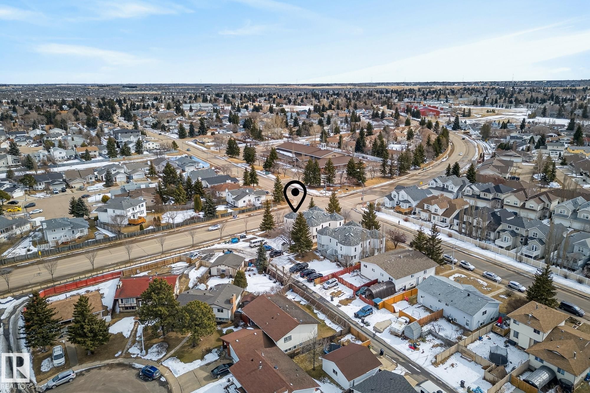 Aerial view of the property and surrounding neighborhood, featuring residential homes, mature trees, and roadways - 2006 Mill Woods Road E, Edmonton, AB - Outdoor With View