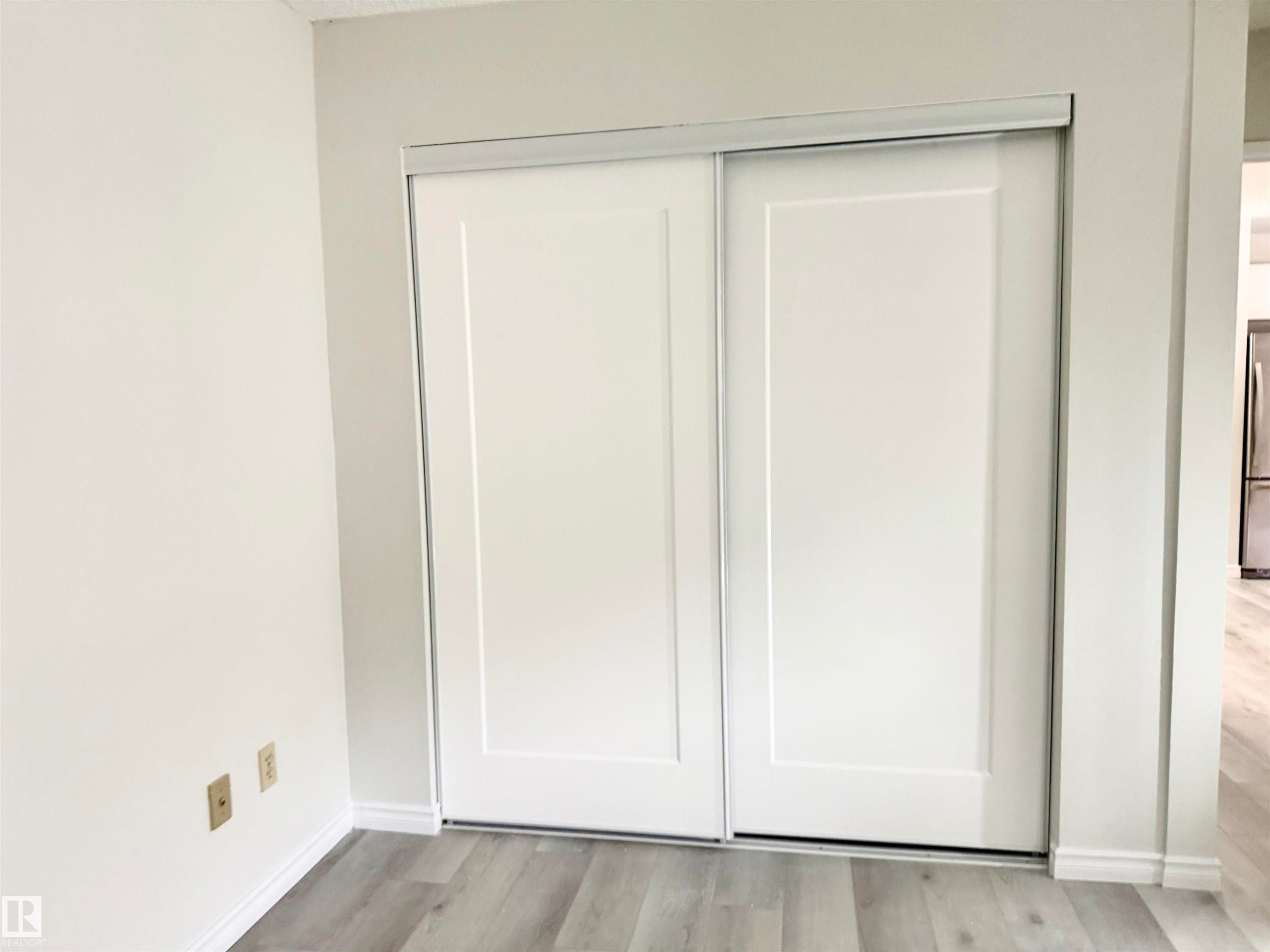 Closet with white sliding doors and light-colored flooring - 307 1620 48 Street, Edmonton, AB