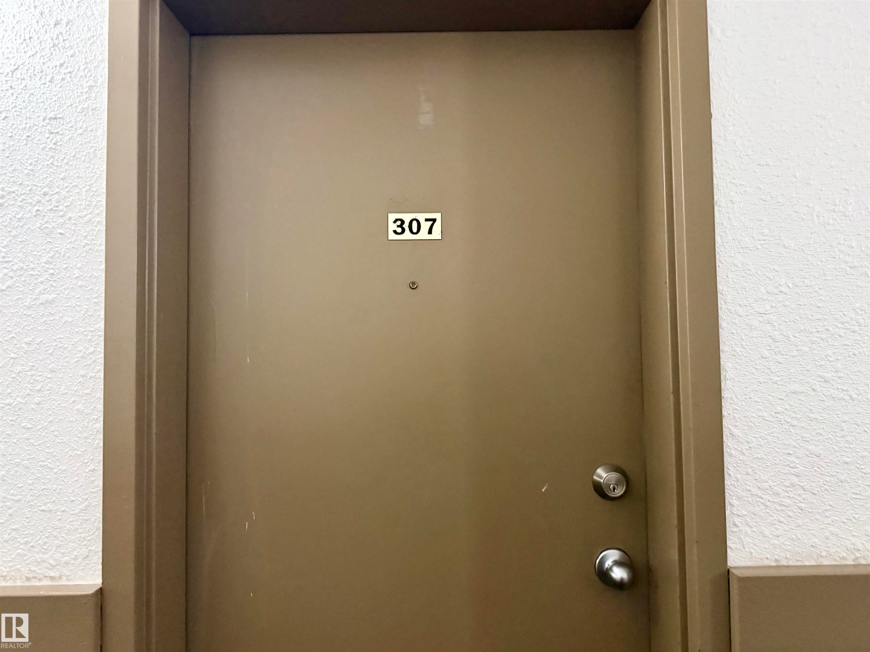 Entry door with contemporary doorknob and deadbolt - 307 1620 48 Street, Edmonton, AB