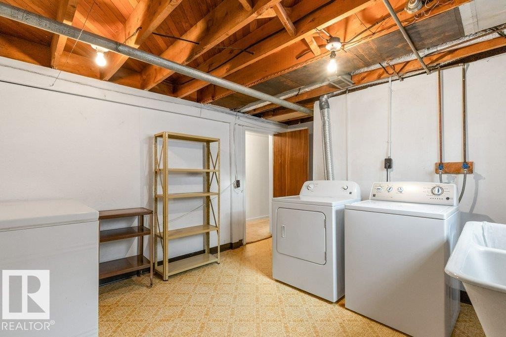 Laundry area featuring light flooring and washing machine and dryer - 8810 93 Street, Edmonton, AB - Indoor Photo Showing Laundry Room