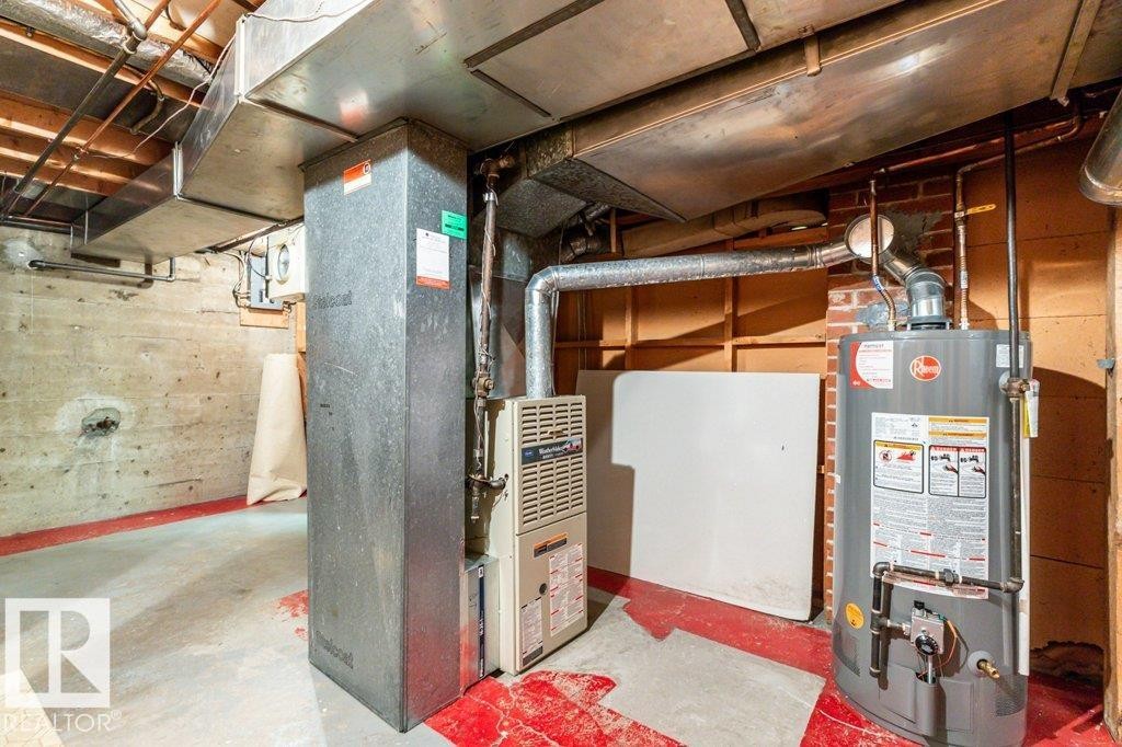 Utilities with heating unit and gas water heater - 8810 93 Street, Edmonton, AB - Indoor Photo Showing Basement