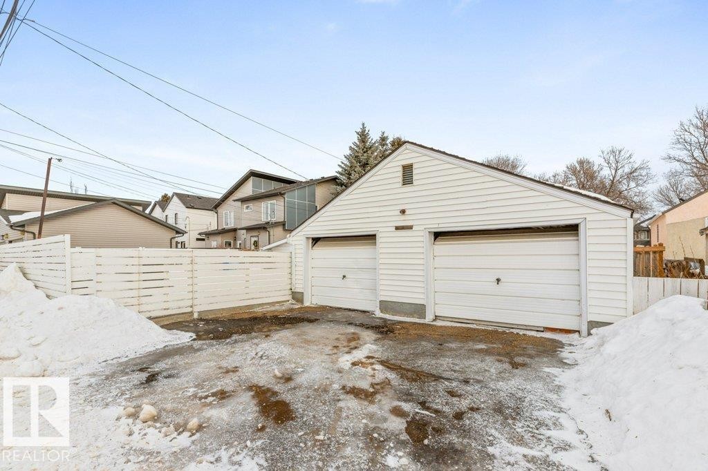 Snow covered garage with a detached garage and a residential view - 8810 93 Street, Edmonton, AB - Outdoor With Exterior