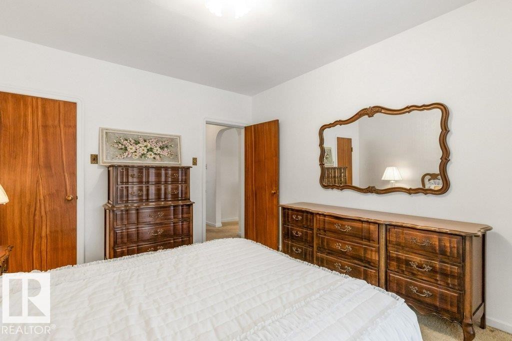 Carpeted bedroom featuring arched walkways - 8810 93 Street, Edmonton, AB - Indoor Photo Showing Bedroom