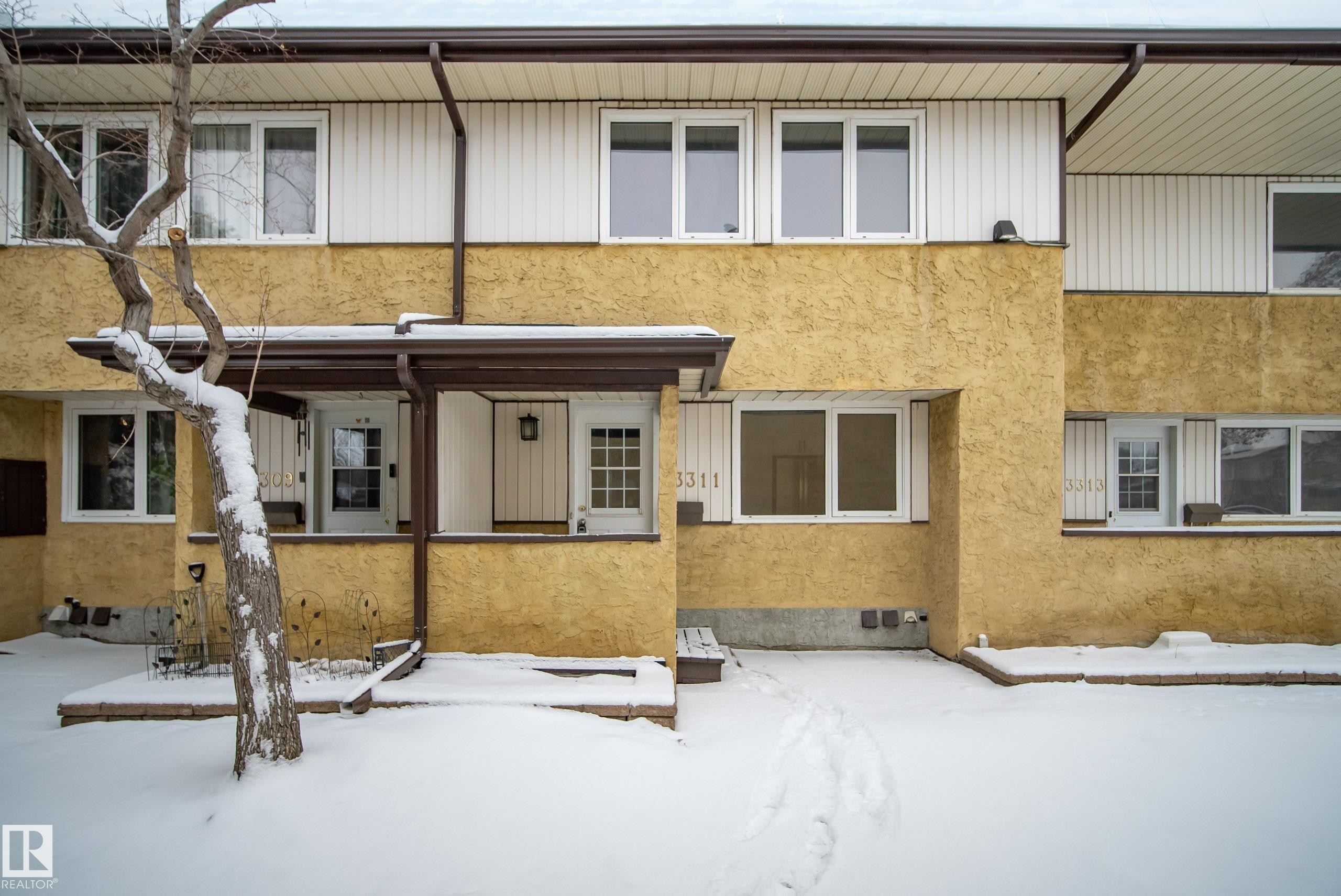 The property features a two-story exterior with a combination of textured stucco and vertical siding - 3311 139 Avenue, Edmonton, AB - Outdoor