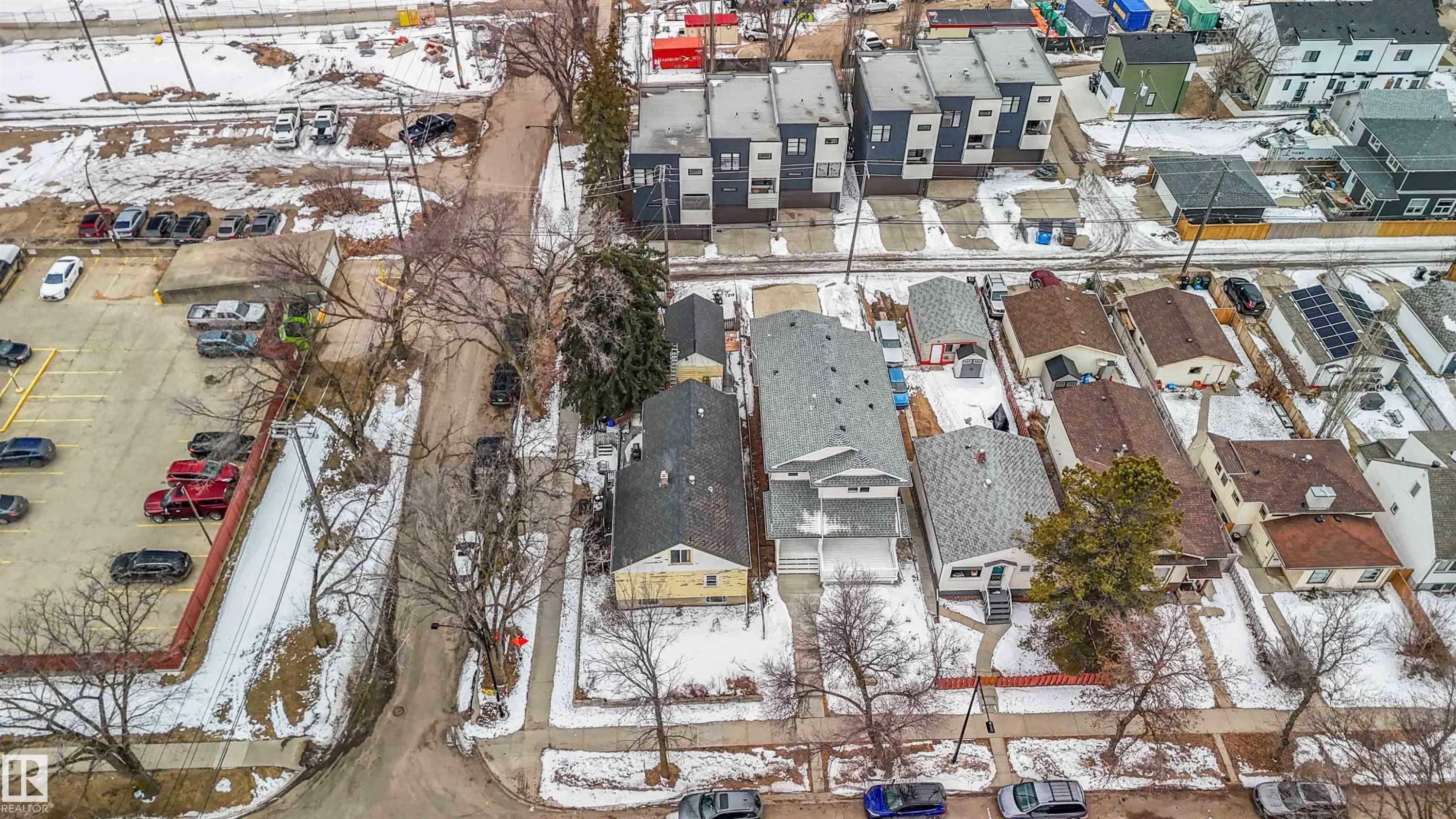This aerial view showcases the property's advantageous position within the neighborhood, featuring access to a paved road and proximity to various other properties - 10186 143 Street, Edmonton, AB - Outdoor With View