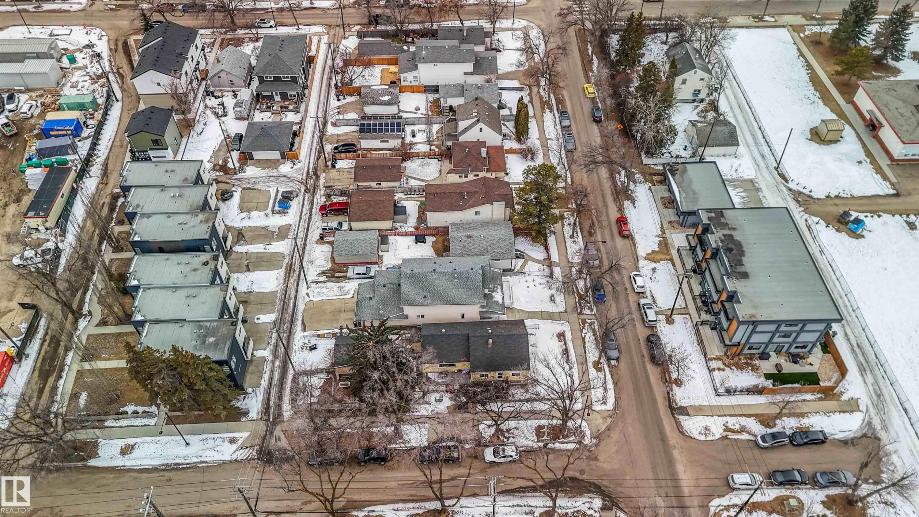Aerial view of the neighborhood showcasing various residential properties along a street, with some properties featuring visible yards - 10186 143 Street, Edmonton, AB
