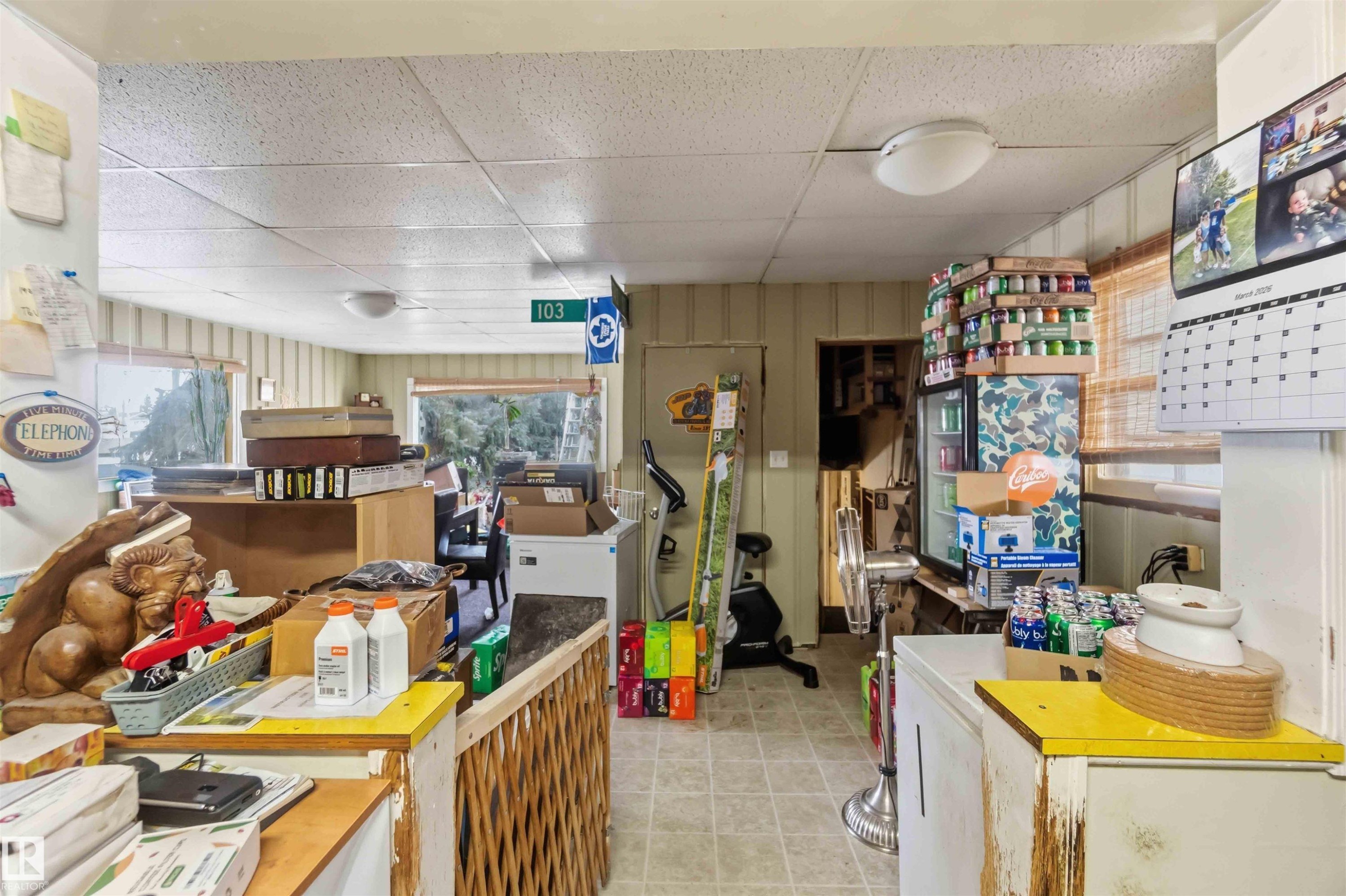 The property features beadboard wall paneling, a drop ceiling, and visible windows - 10186 143 Street, Edmonton, AB - Indoor