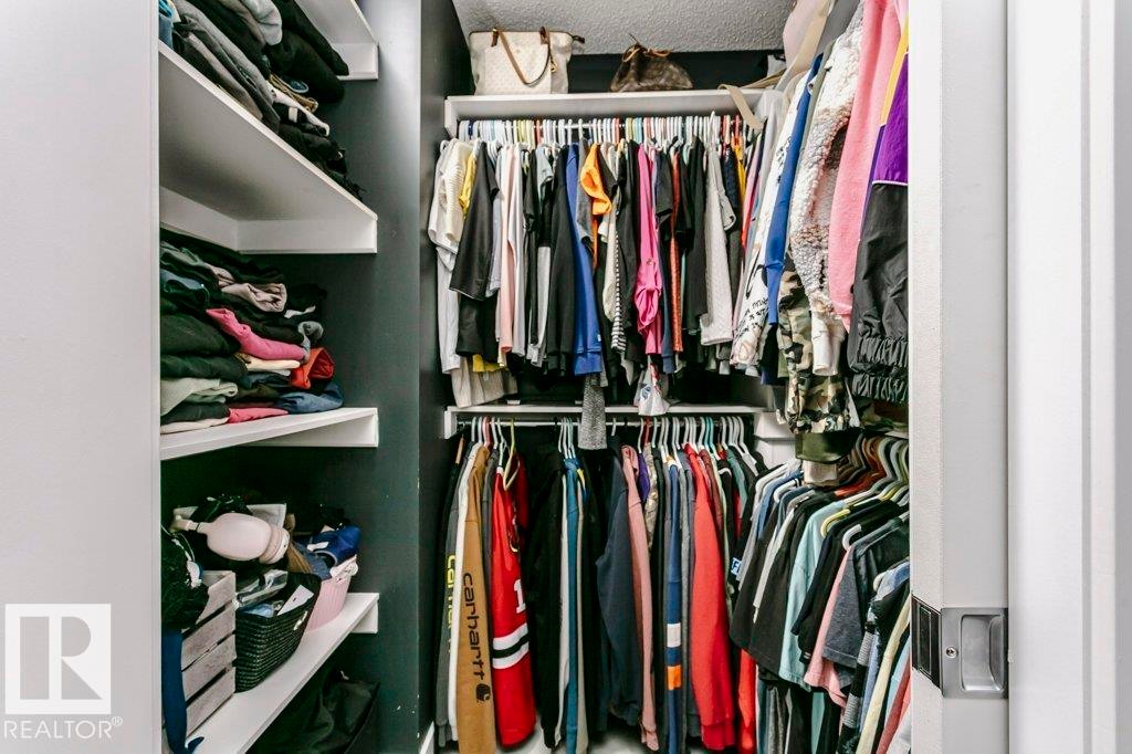 The property features a walk-in closet with white shelving and hanging rods for ample storage - 320 Balsam Link, Leduc, AB - Indoor With Storage