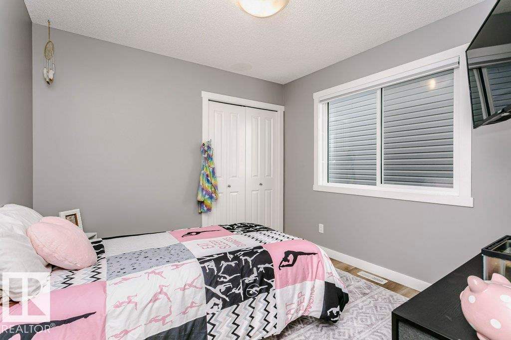 This room features gray walls, a window with horizontal blinds, and a closet with bifold doors - 320 Balsam Link, Leduc, AB - Indoor Photo Showing Bedroom