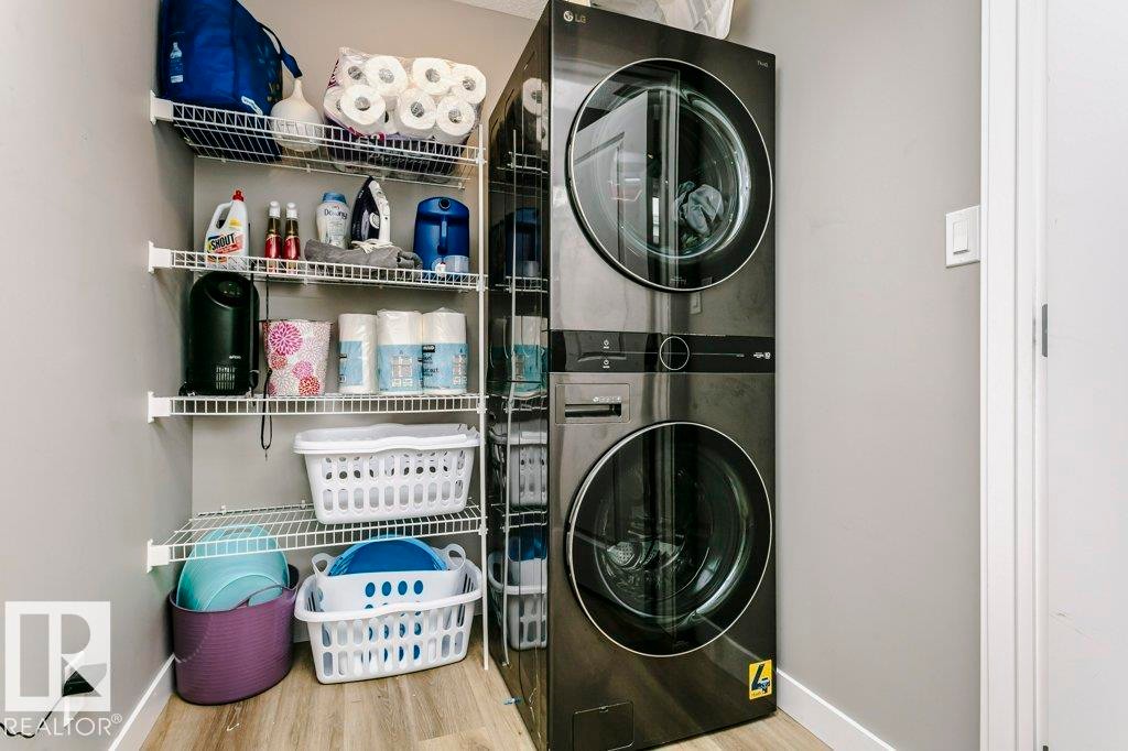 Laundry area featuring a stacked washer and dryer, and wire shelving for storage - 320 Balsam Link, Leduc, AB - Indoor Photo Showing Laundry Room