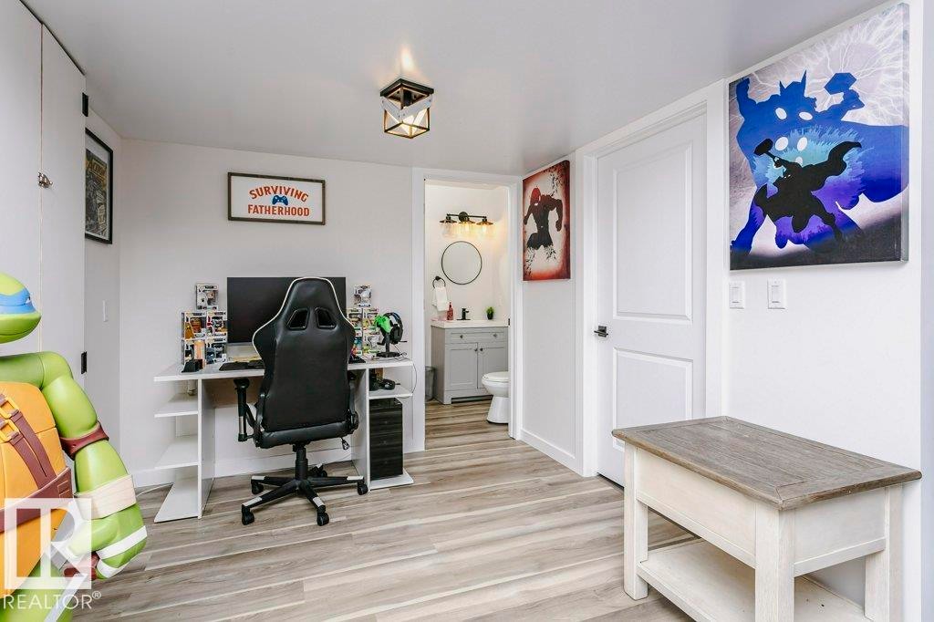 This room features light-colored plank flooring, white walls, and a ceiling light fixture - 320 Balsam Link, Leduc, AB - Indoor Photo Showing Office