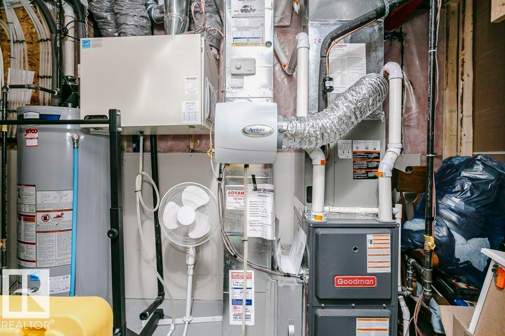 The property includes a Goodman furnace and a water heater, ensuring essential utilities are in place - 320 Balsam Link, Leduc, AB - Indoor Photo Showing Basement