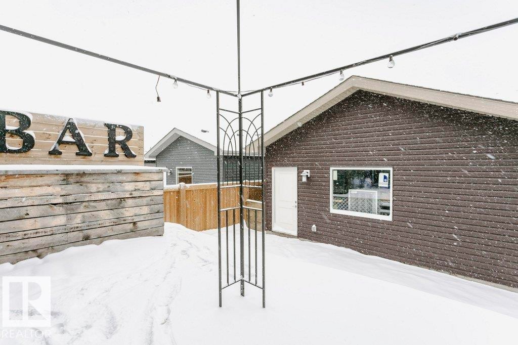 Outdoor area featuring a structure with decorative metalwork and overhead string lights - 320 Balsam Link, Leduc, AB - Outdoor