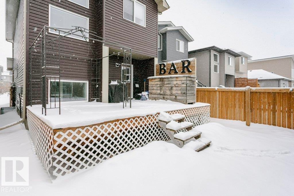 This property features a wooden deck with lattice skirting and steps leading to the yard - 320 Balsam Link, Leduc, AB - Outdoor With Deck Patio Veranda With Exterior