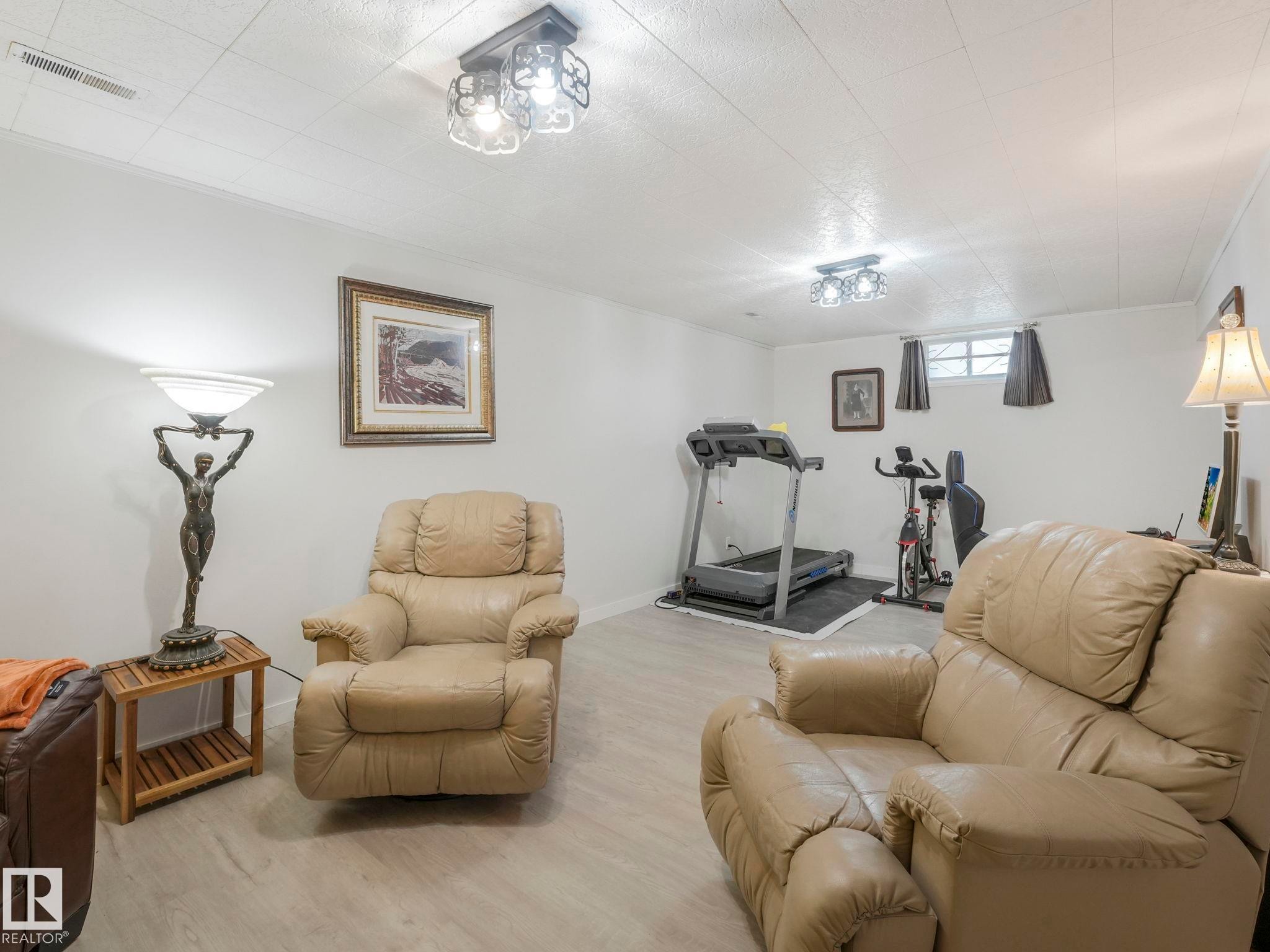 The property features light-colored flooring, white walls, and a ceiling - 16106 79A Avenue Nw, Edmonton, AB - Indoor Photo Showing Gym Room