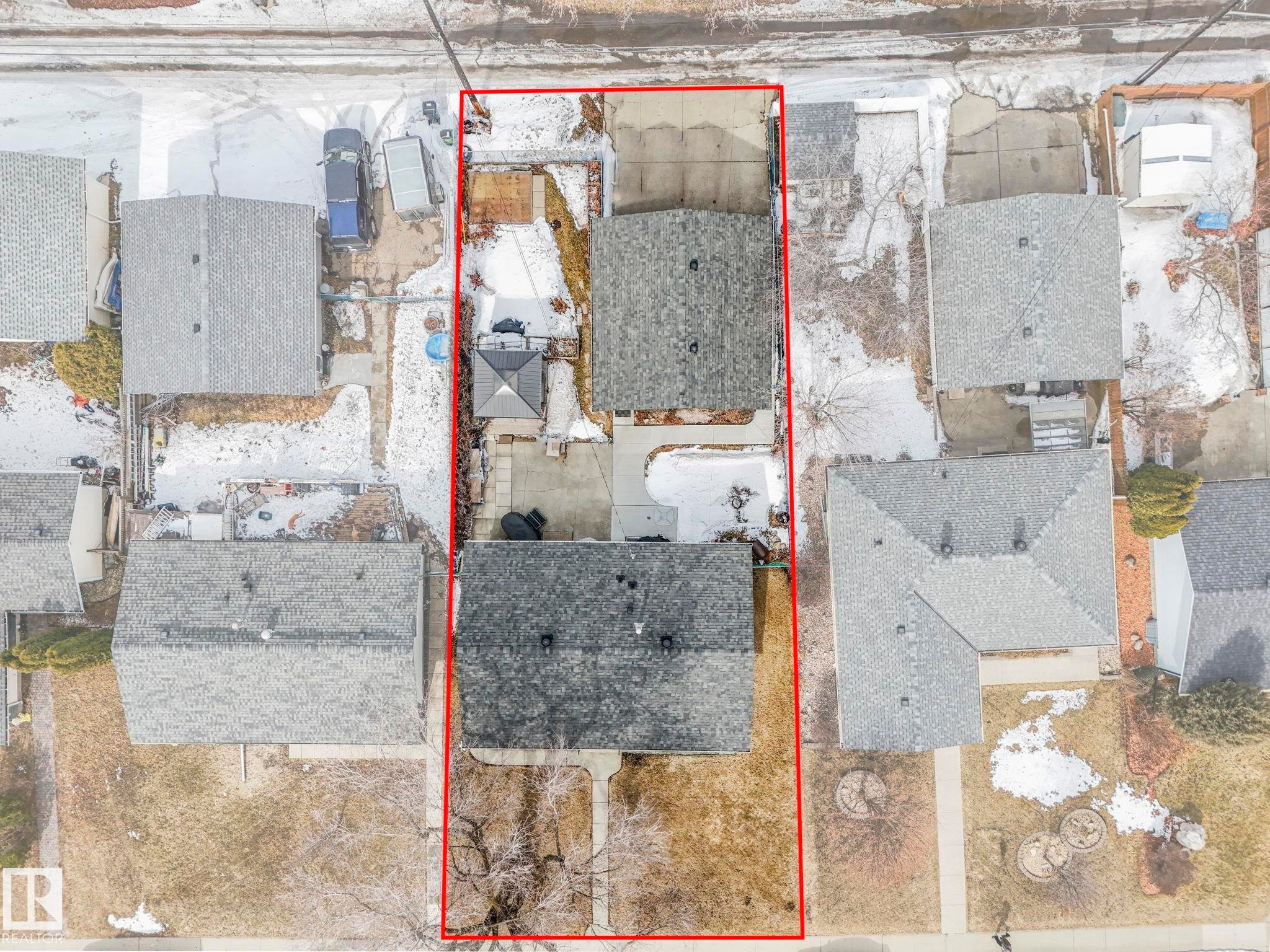 Aerial view showcasing the property's boundaries, two residential structures with gray roofs, and a concrete driveway - 16106 79A Avenue Nw, Edmonton, AB - Outdoor