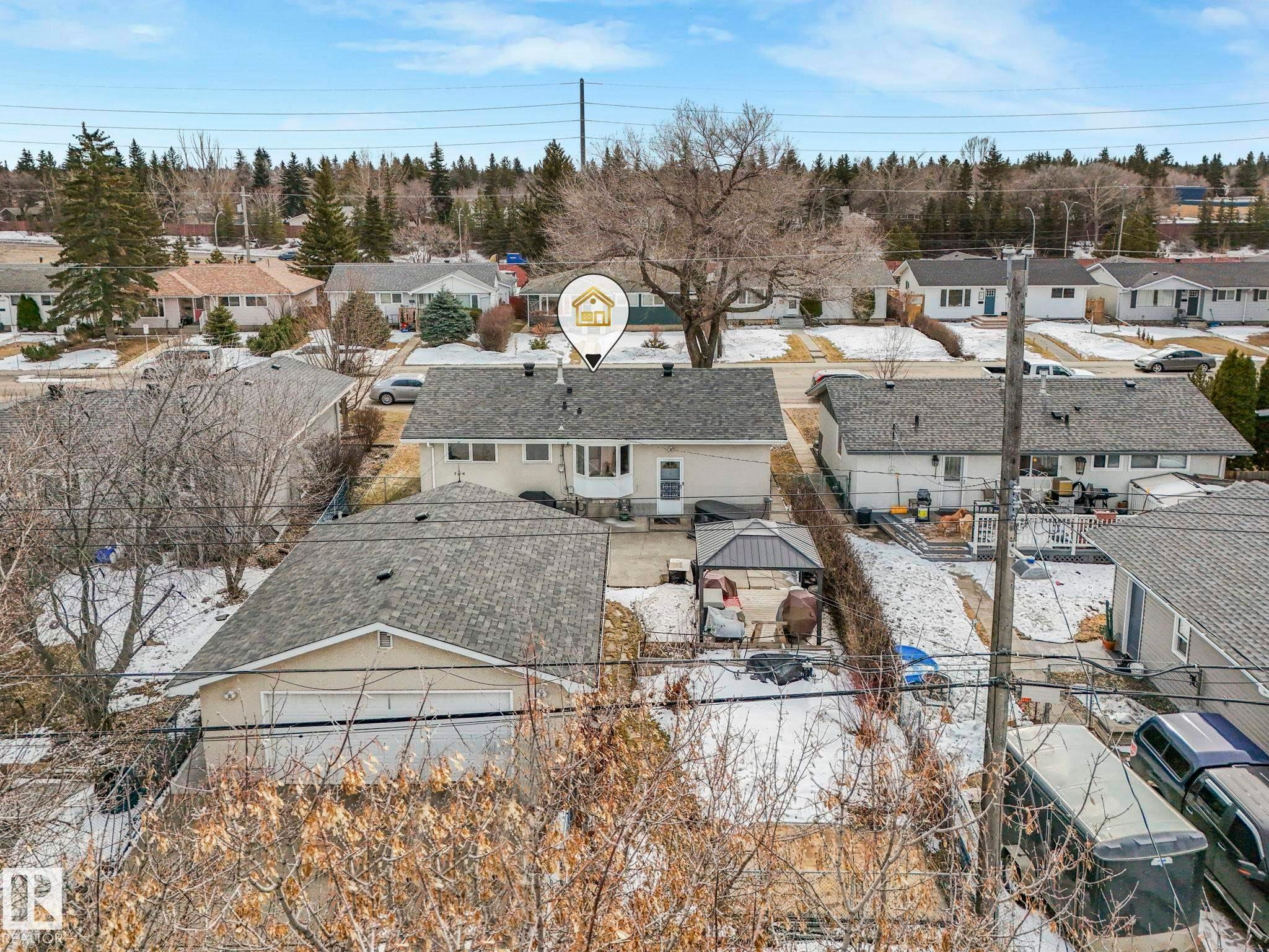 This property features a detached garage with a light-colored exterior and a dark shingled roof, offering practical outdoor storage and parking - 16106 79A Avenue Nw, Edmonton, AB - Outdoor