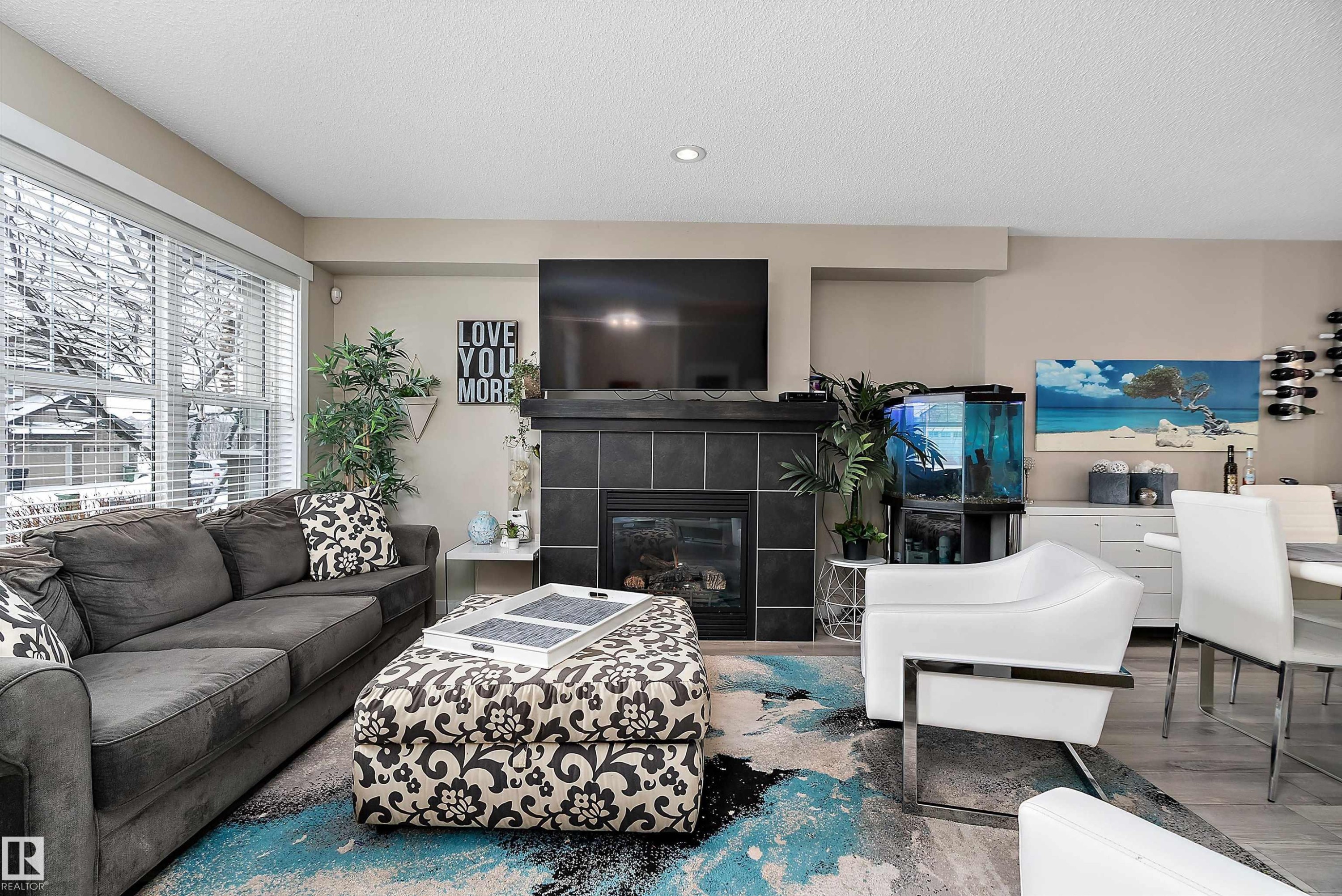 The property features a well-maintained yard with a lawn and a decorative garden area - 2914 18A Avenue, Edmonton, AB - Outdoor With Deck Patio Veranda