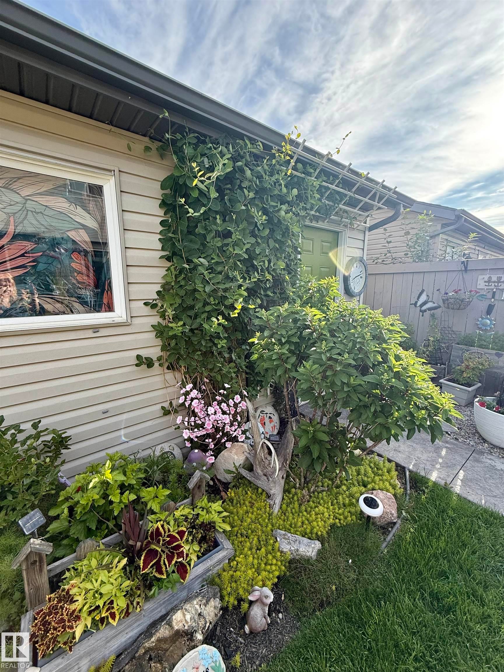 The property features a well-maintained exterior with siding and a stained-glass window - 2914 18A Avenue, Edmonton, AB - Outdoor