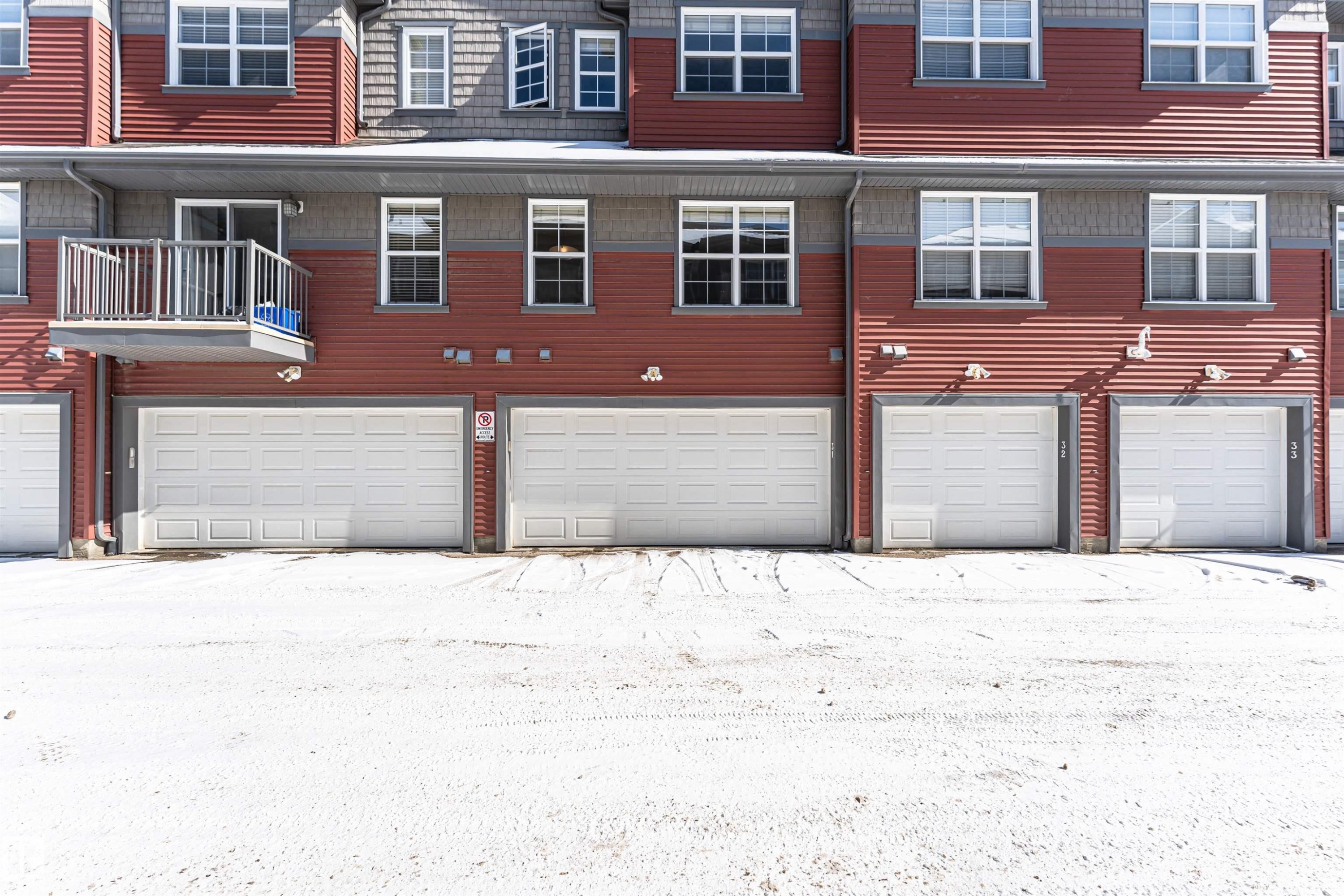The property features a red facade with gray trim and white-framed windows - 31 4029 Orchards Drive, Edmonton, autreother - Outdoor