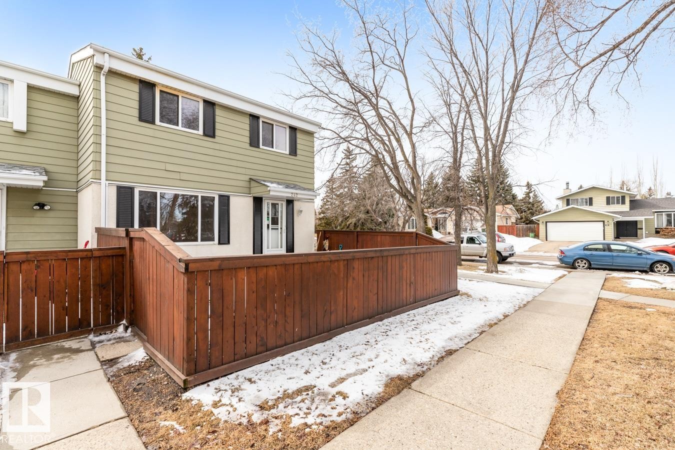 This property features a two-story exterior with horizontal siding and a private fenced outdoor area - 242 Primrose Gardens, Edmonton, AB - Outdoor