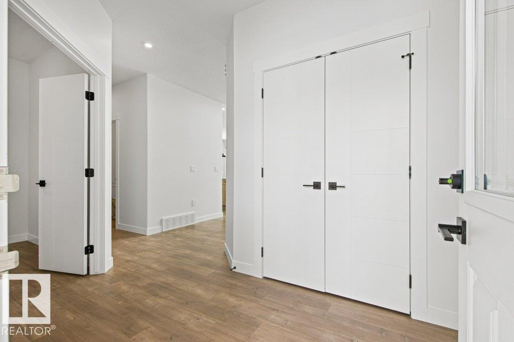 Entryway featuring light wood-style flooring, white walls, and a recessed ceiling light - 5018 53 Avenue, Calmar, AB - Indoor Photo Showing Other Room