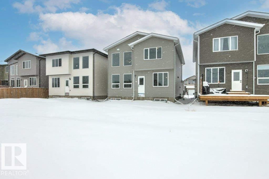 The property features a spacious backyard with a wooden deck, providing an opportunity for outdoor enjoyment - 5018 53 Avenue, Calmar, AB - Outdoor With Facade