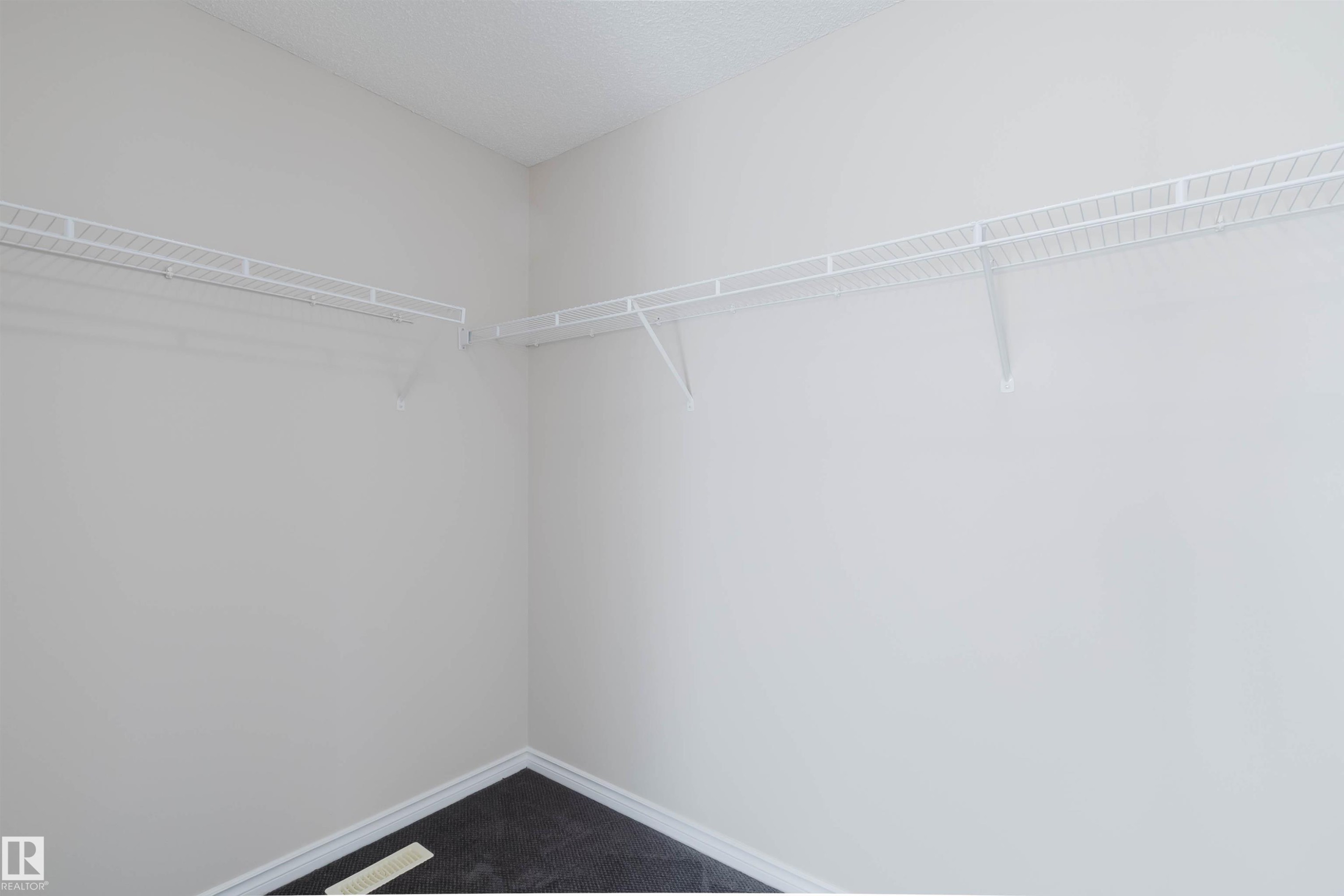 This closet features white wire shelving providing storage space and dark flooring - 1135 112 Street, Edmonton, AB - Indoor With Storage