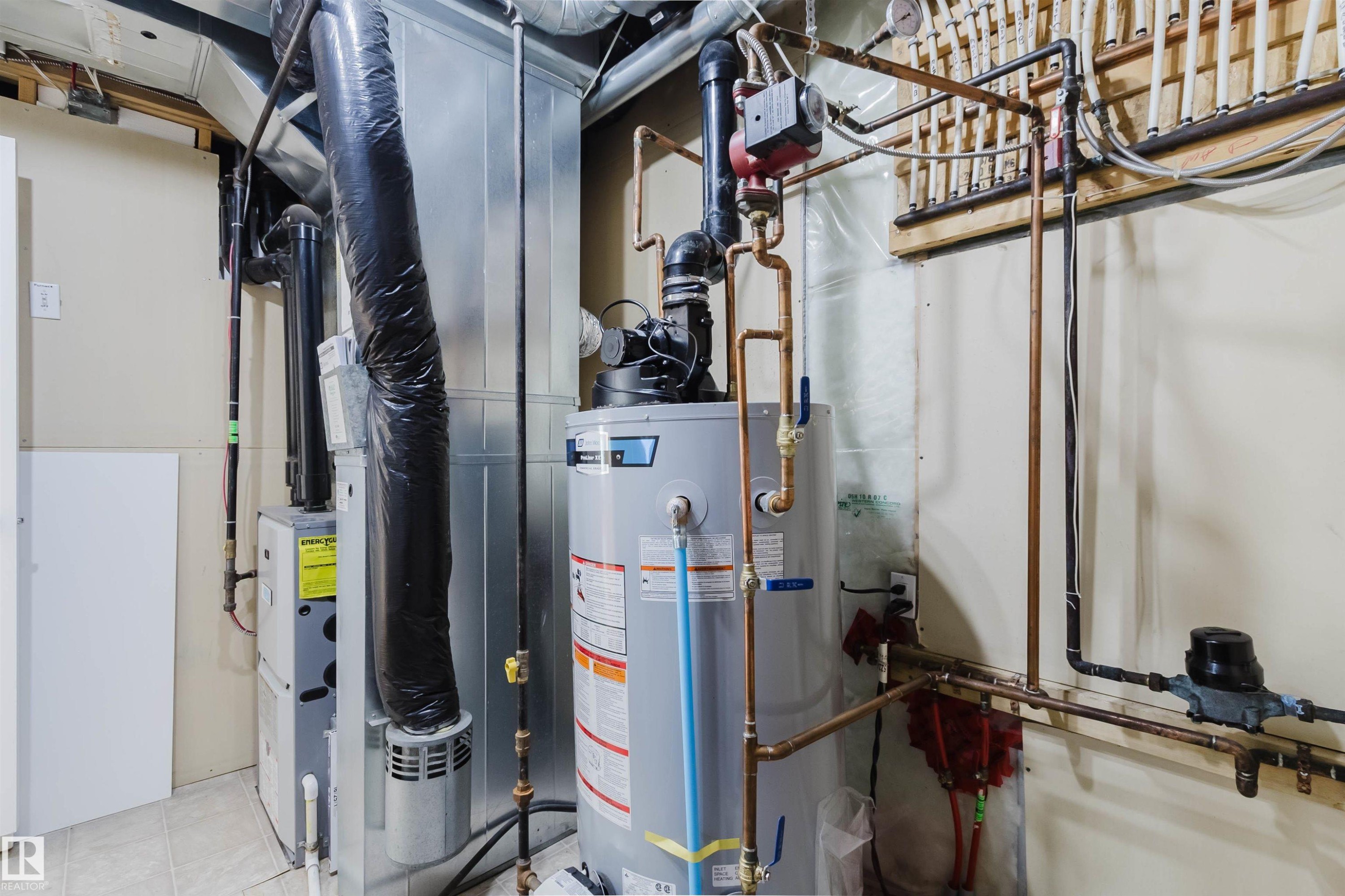 Utility area featuring a water heater, furnace, and visible copper piping - 1135 112 Street, Edmonton, AB - Indoor Photo Showing Basement