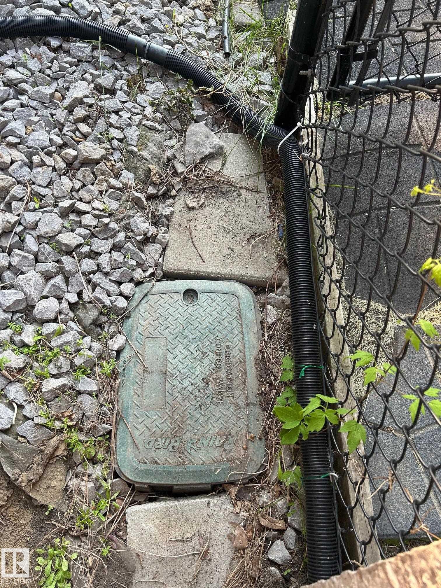 The property features a utility access panel and a black chain link fence - 1135 112 Street, Edmonton, AB - Outdoor