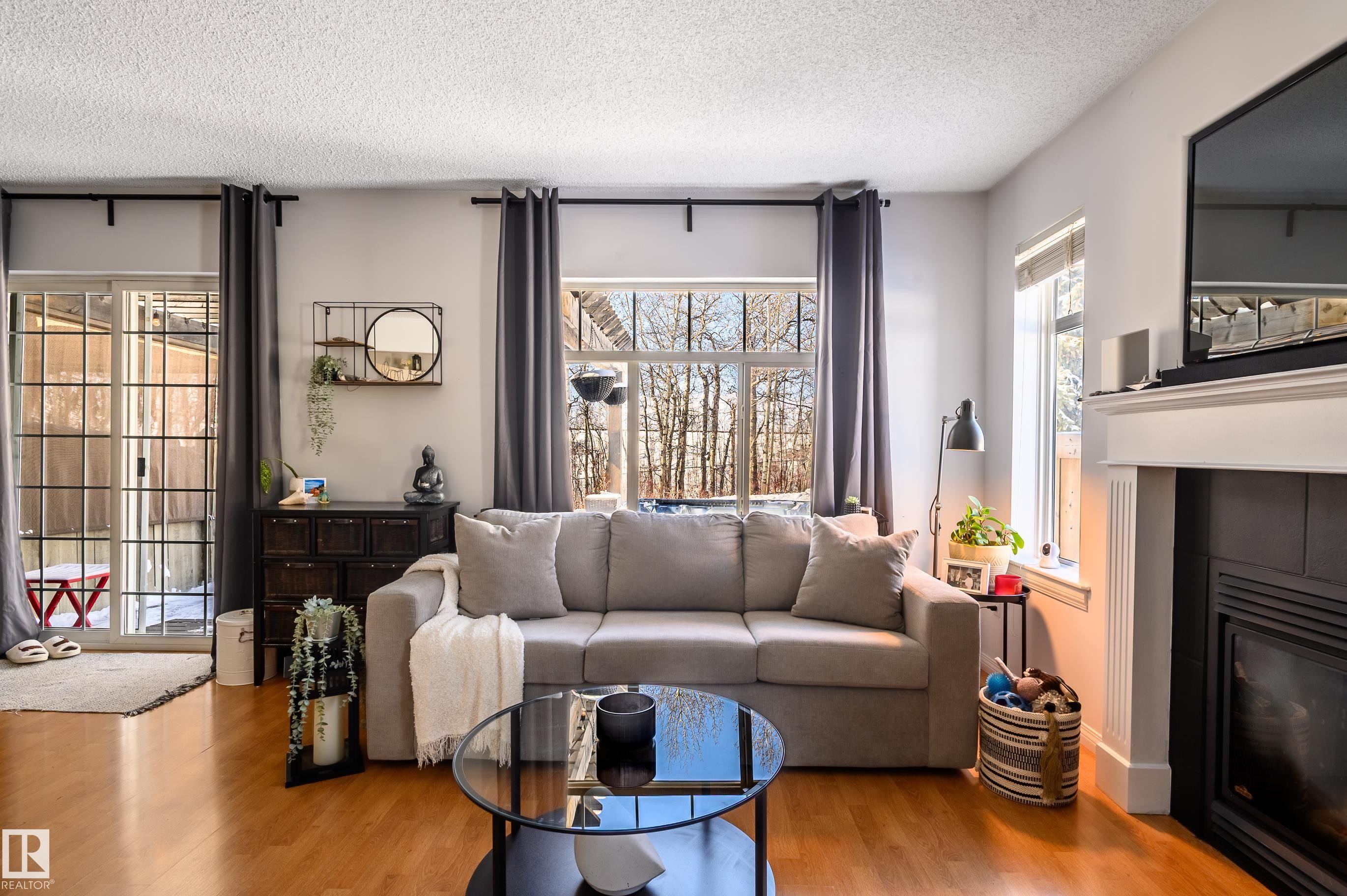 1 30 Levasseur Road, St. Albert, AB - Indoor Photo Showing Living Room With Fireplace