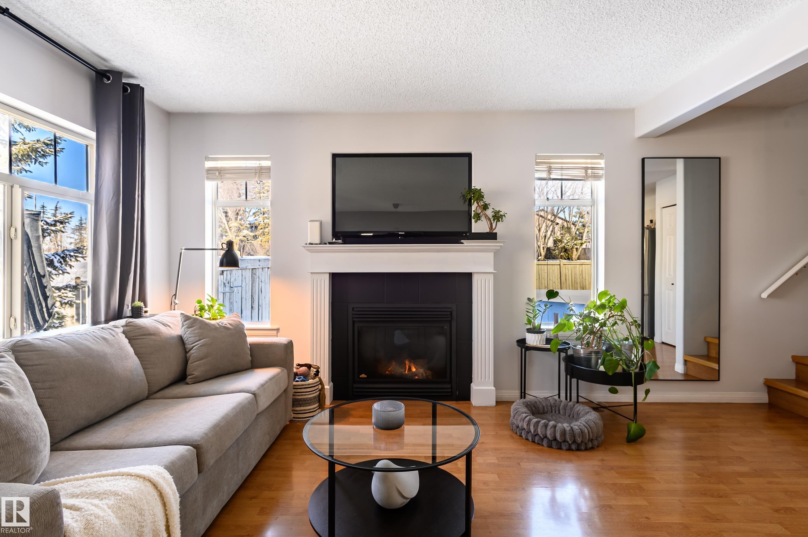 1 30 Levasseur Road, St. Albert, AB - Indoor Photo Showing Living Room With Fireplace