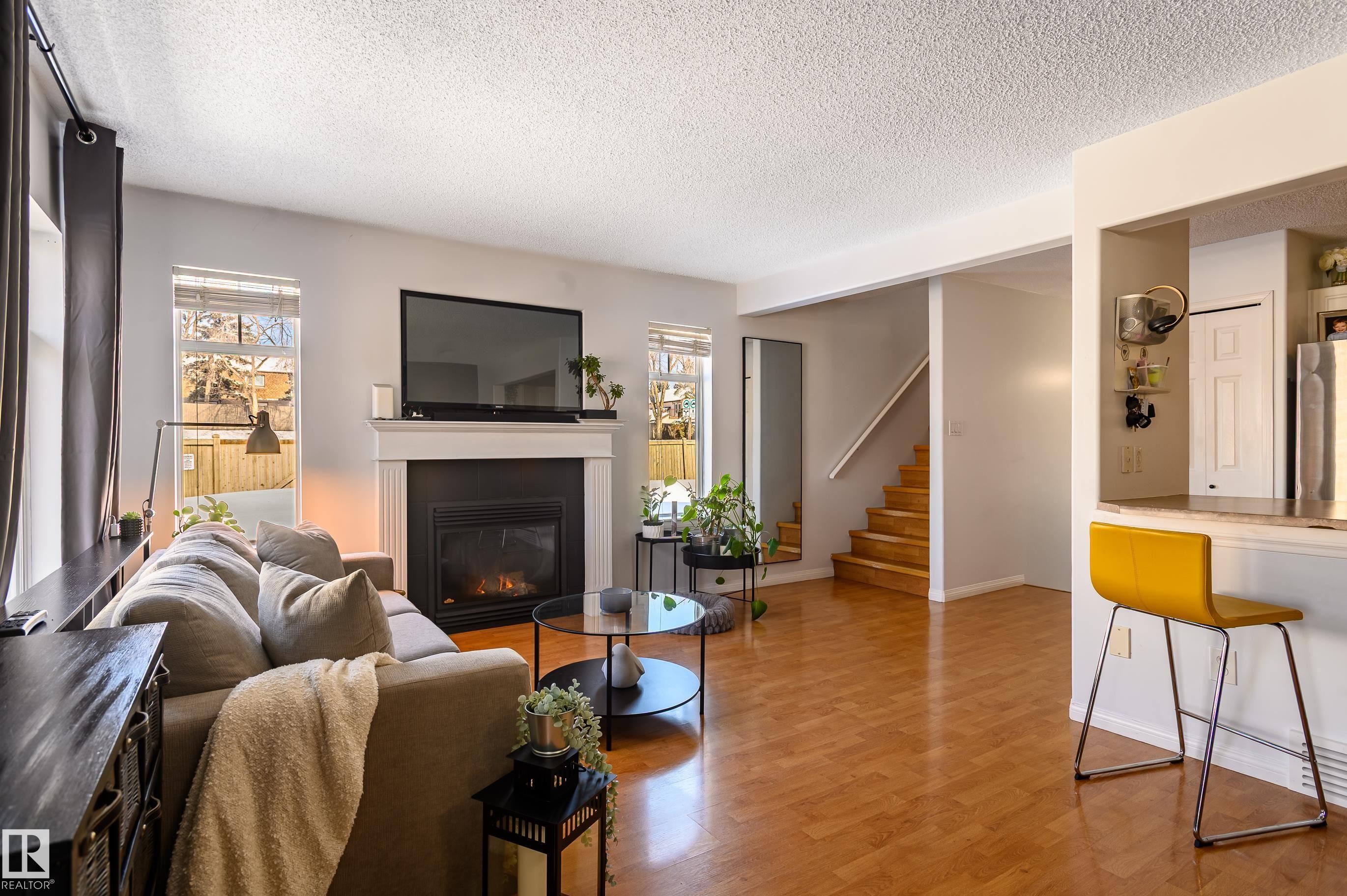 1 30 Levasseur Road, St. Albert, AB - Indoor Photo Showing Living Room With Fireplace