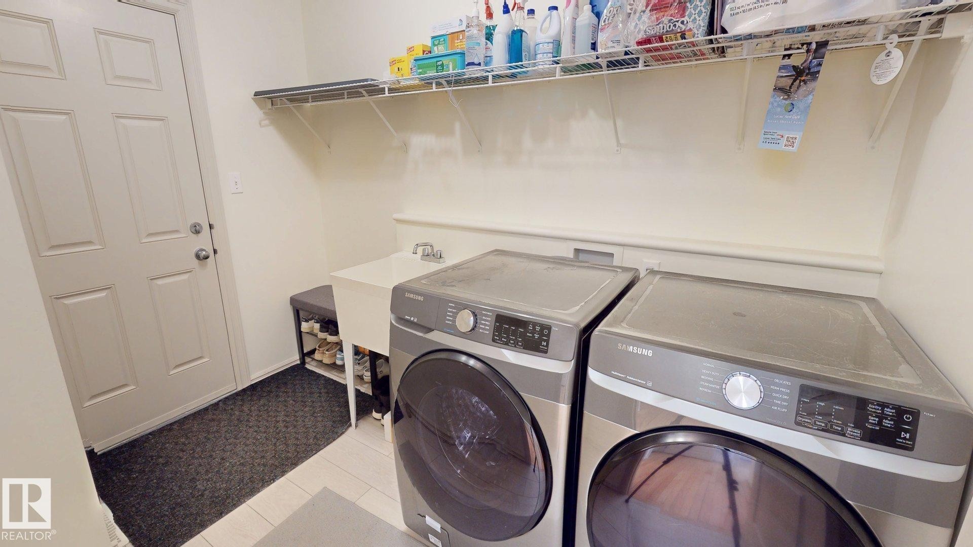 Dedicated utility area featuring a sink, shelving, and space for a washer and dryer - 1609 Hodgson Crest, Edmonton, AB - Indoor Photo Showing Laundry Room
