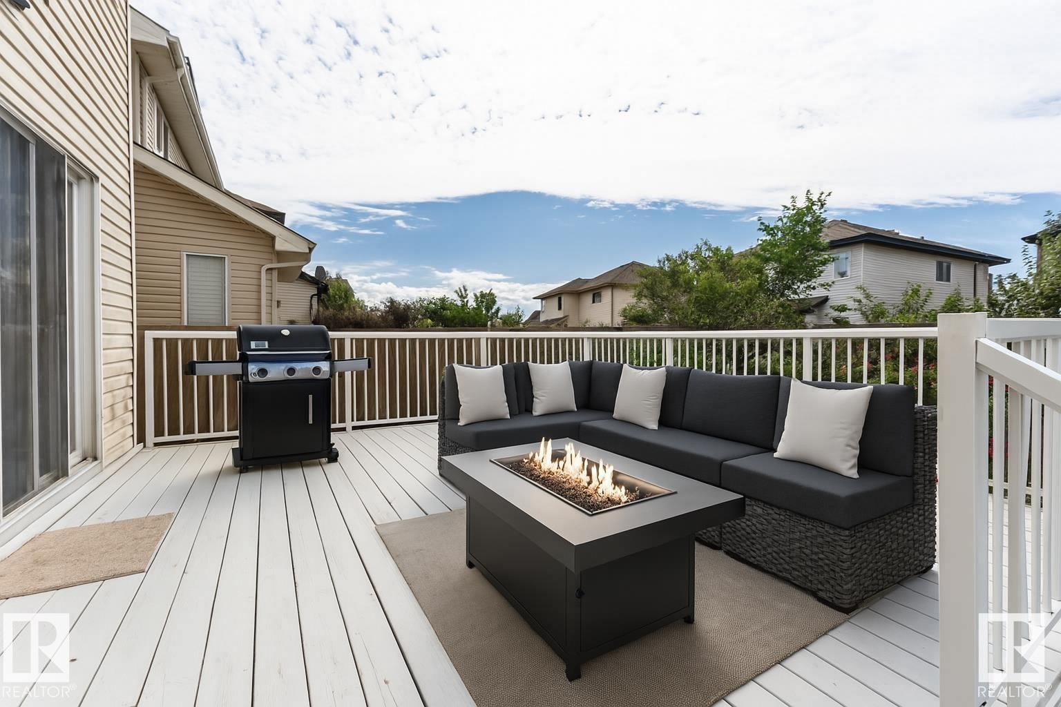 This property features a spacious outdoor deck with white railings, offering ample room for entertaining - 1609 Hodgson Crest, Edmonton, AB - Outdoor With Deck Patio Veranda With Exterior