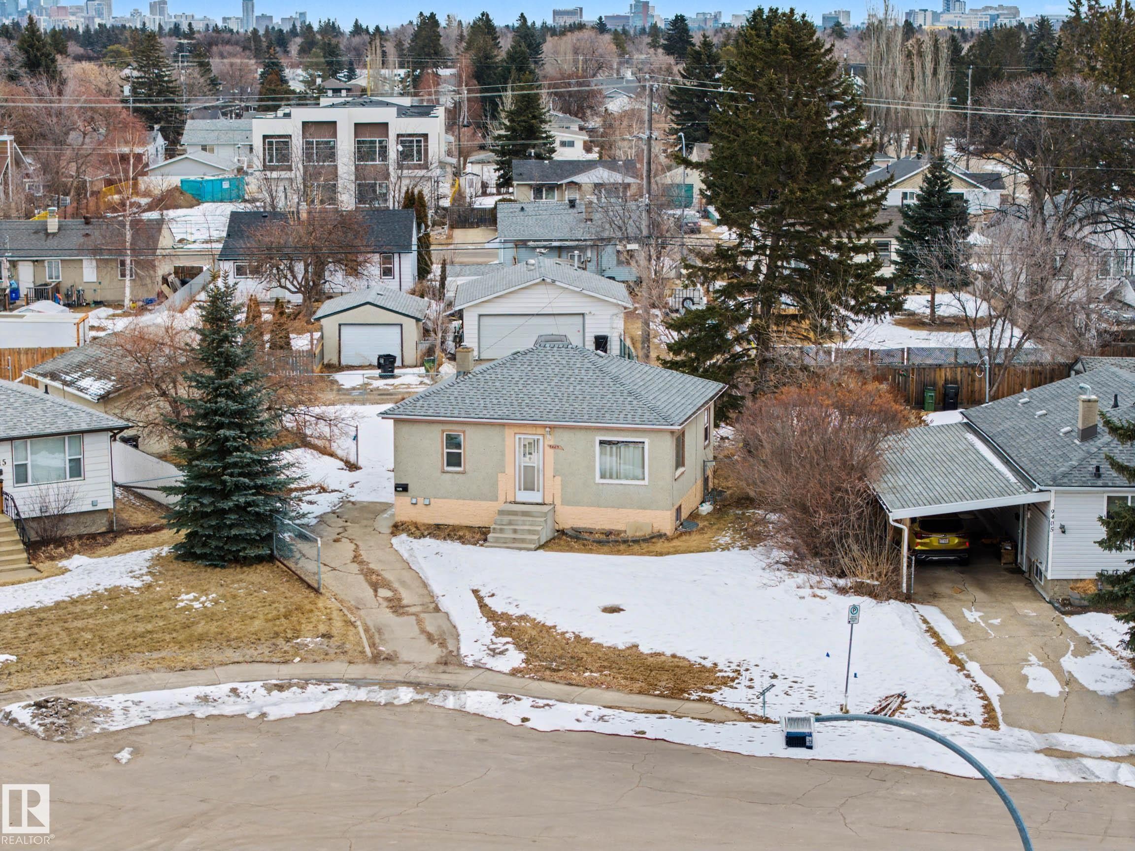 The property features a main house with a light-colored exterior and a covered front entrance - 9409 154 Street, Edmonton, AB - Outdoor