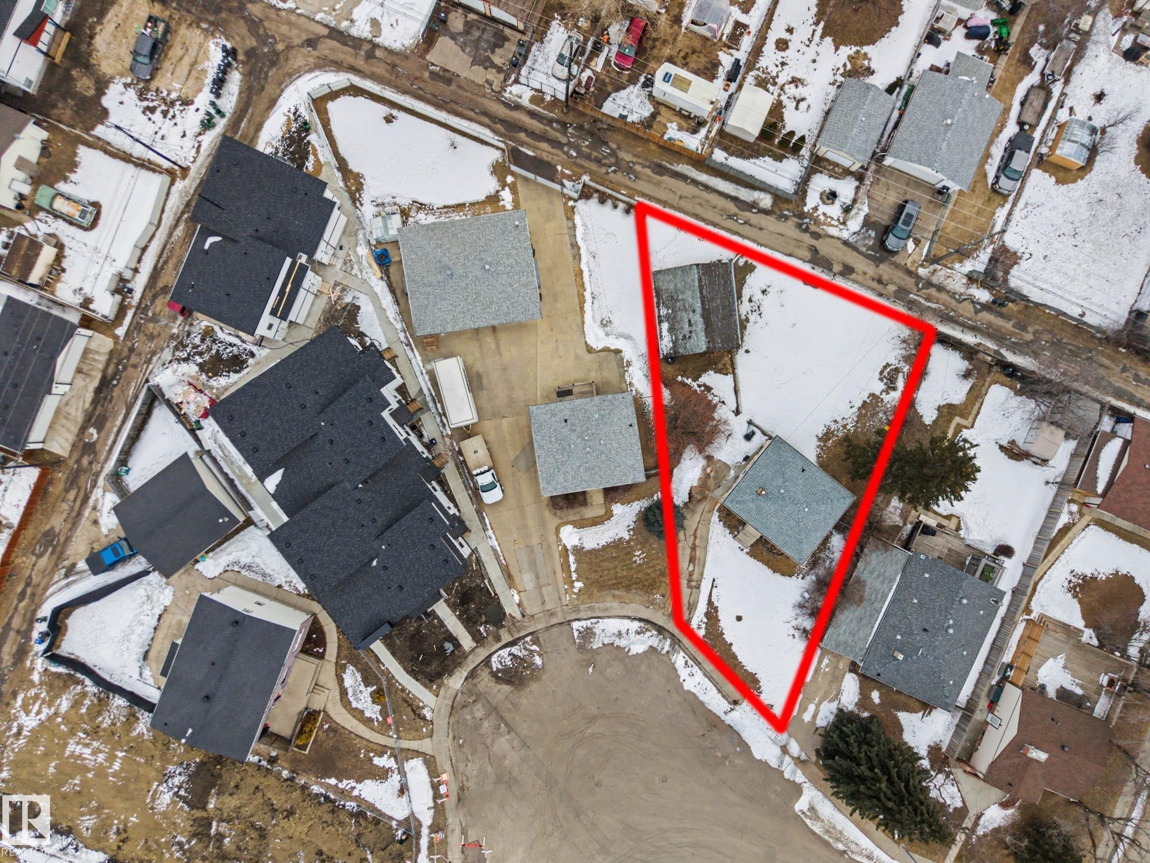 Aerial view of the property, outlined in red, featuring a building with a dark roof and a surrounding yard with some trees - 9409 154 Street, Edmonton, AB - Indoor Photo Showing Basement