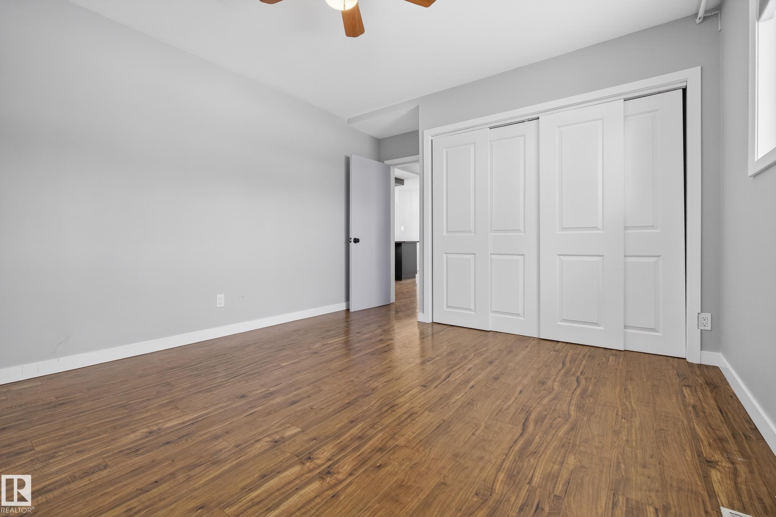 This room features wood-look flooring and light grey walls - 3613 113 Avenue, Edmonton, AB - Indoor Photo Showing Other Room